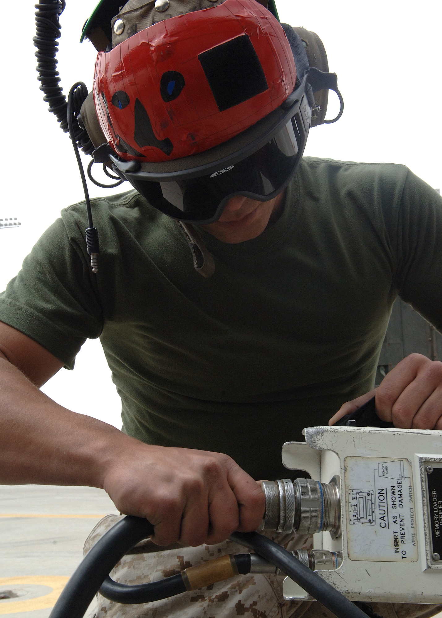 Corporal Anthony Edge of the of the Marine Fighter Attack Squadron plugs a cable into a power pack on Holloman Air Force Base, N.M. April 11, 2008.  The Marine Fighter Attack Squadron is train of the Marine Fighter Attack Squadron on Holloman Air Force Base, N.M. April 11, 2008.  The Marine Fighter Attack Squadron is training here on Holloman with the f-18 hornet to prepare for an upcoming deployment.