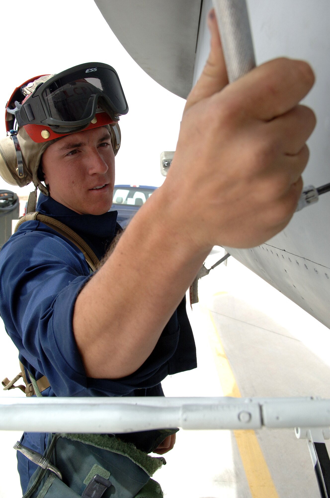 Lance Corporal Joshua Johnson of the Marine Fighter Attack Squadron tightens a bolt on the f-18 hornet on Holloman Air Force Base, N.M. April 11, 2008.  The Marine Fighter Attack Squadron is training here on Holloman with the f-18 hornet to prepare for an upcoming deployment.
