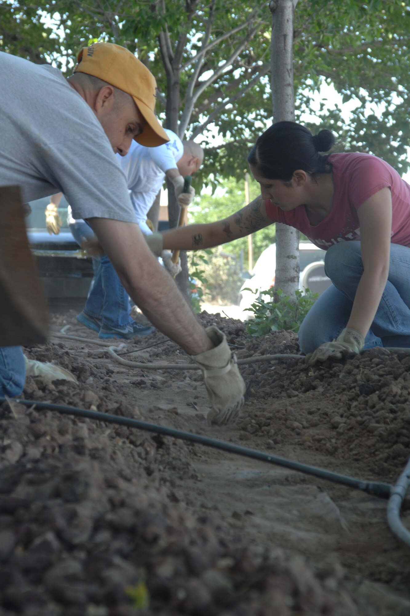 ALAMOGORDO, N.M.--Tech. Sgt. James Henderson and Airman 1st Class Sabrina Garcia landscape April 24 during the United Way of Otero County Day of Caring in Alamogordo, N.M. Both are of the 49th Logistics Readiness Squadron's Fuels Managment Flight. (U.S. Air Force photo/Airman 1st Class Jamal D. Sutter)