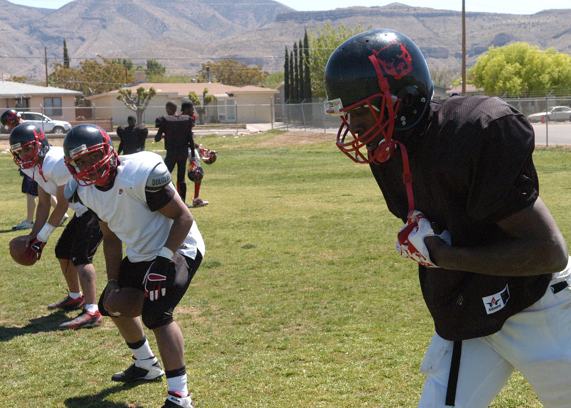 Airman First Class Andre Powell (Wide receiver) of the 49th Comptrollers Squadron listens for the play call from Senior Airman Anthony Nelson (Quarterback) of the 49th Fighter Wing Public Affairs office on April 12 2008 in Alamogordo, N.M.  