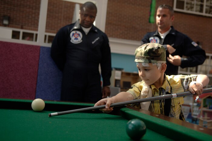 Caleb Dennis plays pool with Tech. Sgt. Ernest "Big E" Hall III and Staff Sgt. John "Turbo" Lebold from the Thunderbirds at the Medical University of South Carolina April 25. Caleb is a 6-year-old boy who had plans to see the 2008 "Wings Over Charleston" Air Expo but was unexpectedly admitted to the hospital due to medical reasons the day before. Sergeant Hall, a system administrator, and Sergeant Lebold, an airlift coordinator, use the nicknames "Big E" and "Turbo" as ice-breakers when visiting children in various hospitals.  (U.S. Air Force photo/Senior Airman Nicholas Pilch)