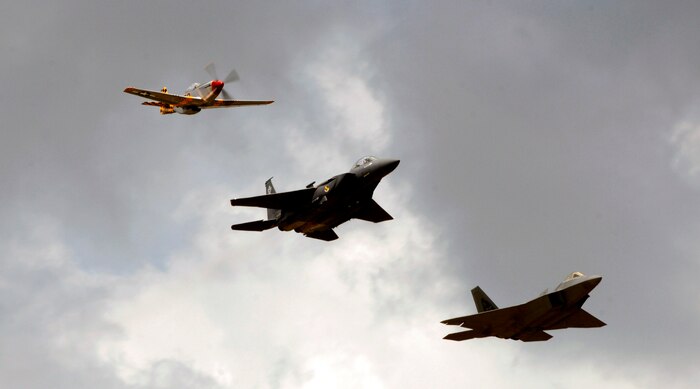 A P-51 Mustang piloted by Dale Snodgrass, a F-15E Strike Eagle piloted by Capts. Phil Smith and Ed Colfer, and an F-22 Raptor, piloted by Maj. Paul Moga, fly over show center during a heritage flight for the 2008 "Wings Over Charleston" Air Expo April 26. The heritage flight displays featured aircraft from the past and present. (U.S. Air Force photo/Senior Airman Nicholas Pilch)