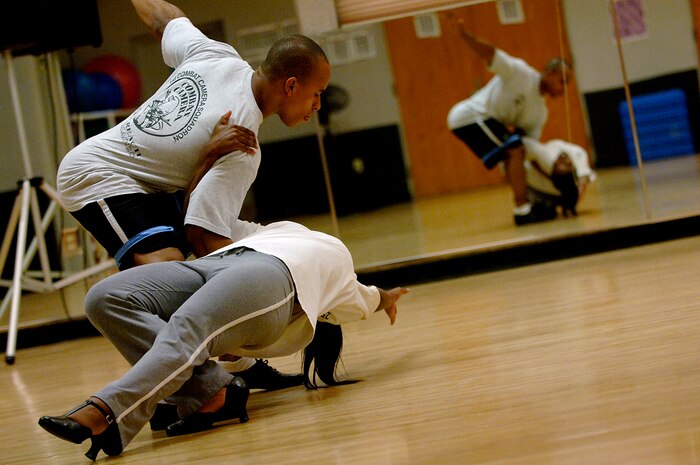 Kirton Madison dips his wife, Danielle, during salsa dancing practice at the Fitness and Sports Center April 29.  The dancers are preparing for a performance that is open to the base May 30 at 9 p.m. in the Charleston Club. Madison is with the 1st Combat Camera Squadron. (U.S. Air Force photo/Senior Airman Nicholas Pilch)
