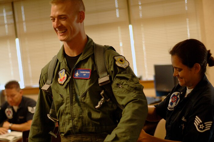 Staff Sgt. Robbin Bailon fits Staff Sgt. Phillip King for aircrew life support equipment before a hometown hero flight at Charleston AFB with the Air Force Thunderbirds April 24. The Thunderbirds team offered a flight to Sergeant King while they were practicing for the air expo as a way of thanking him for his service. Sergeant King is with the 437th Security Forces Squadron and Sergeant Bailon is with the Thunderbirds. (U.S. Air Force photo/Senior Airman Nicholas Pilch)