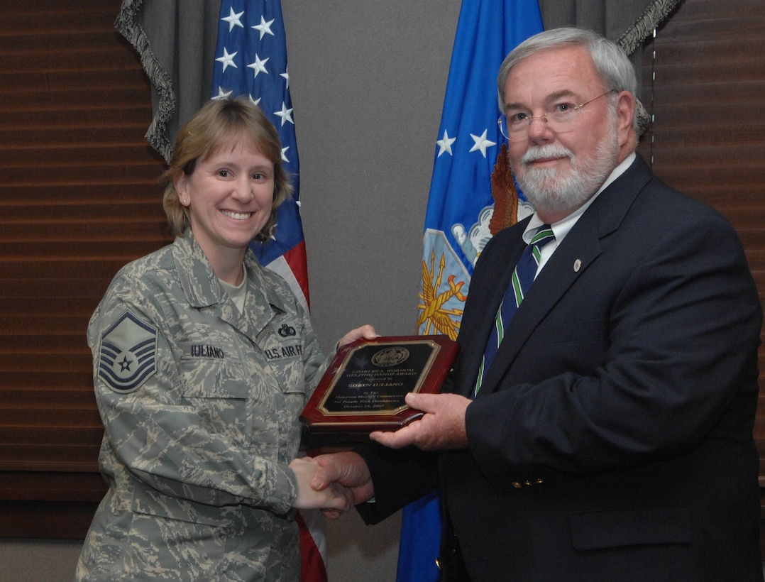 LANGLEY AIR FORCE BASE, Va. -- Master Sgt. Robin Iuliano is presented the Helping Hands Award, by Mayor Ross A. Kearney, here April 29. Sergeant Iuliano received this award for her volunteer efforts within the Hampton community. She puts local families in touch with agencies so that the appropriate and necessary assistance can be provided. Sergeant Iuliano is an active member of the Special Education Committee for Hampton and special training sessions. (U.S. Air Force Photo by Senior Airman Cecil C. McCloud) 