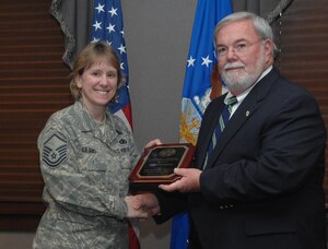 LANGLEY AIR FORCE BASE, Va. -- Master Sgt. Robin Iuliano is presented the Helping Hands Award, by Mayor Ross A. Kearney, here April 29. Sergeant Iuliano received this award for her volunteer efforts within the Hampton community. She puts local families in touch with agencies so that the appropriate and necessary assistance can be provided. Sergeant Iuliano is an active member of the Special Education Committee for Hampton and special training sessions. (U.S. Air Force Photo by Senior Airman Cecil C. McCloud) 