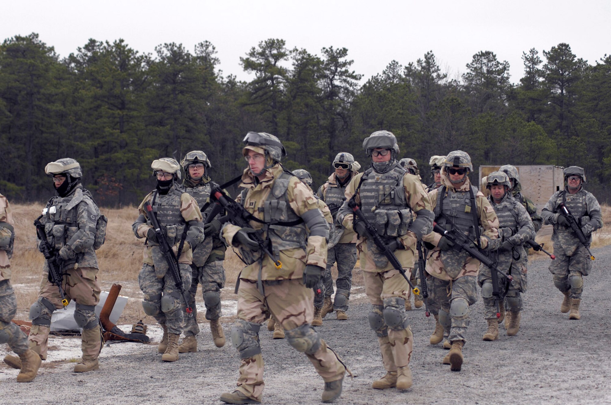 Airmen march toward a mock village during Individual Movement Technique training at the Fort Dix, N.J., improvised explosive device range.  The training teaches troops how to conduct maneuvers in an unknown, often hostile, environment.  The Airmen, members of USAF Class 25, are completing the Soldier Skills Training Course as they prepare for various deployments around the globe.  There are about 75 Airmen currently going through the month-long course.   (U.S. Army photo)