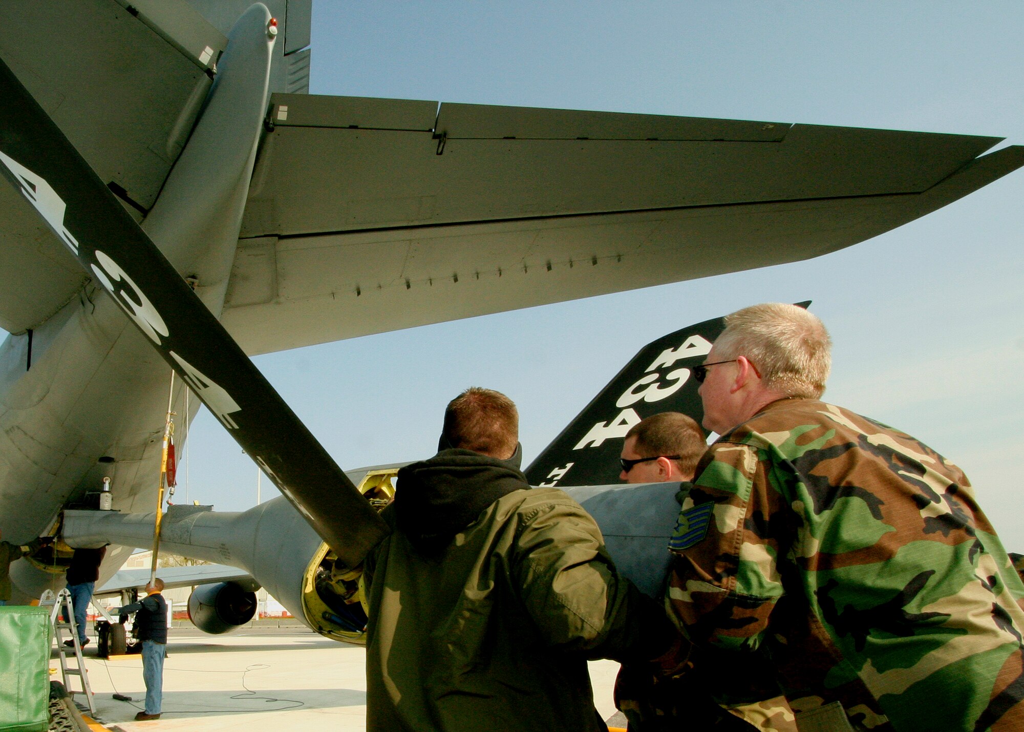 GRISSOM AIR RESERVE BASE, Ind.,-- Three members of the 434th Maintenance Group move a refueling boom into position during maintenance activities on the Grissom flightline.  The boom on the KC-135 Stratotanker is used to transfer jet fuel during mid-air refuelings.  KC-135s from the 434th Air Refueling Wing provide vital aerial refuelings to fighter, bomber and cargo aircraft. (U.S. Air Force Photo/Tech. Sgt. Patrick M. Kuminecz)