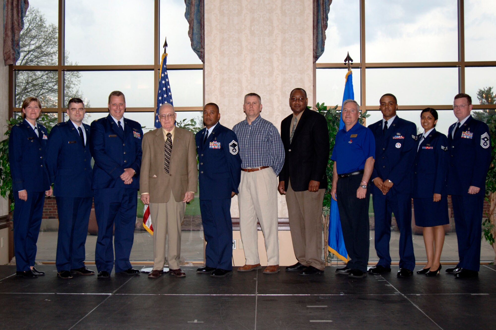 SCOTT AIR FORCE BASE, Ill. -- Col. Tamra Rank (left), 375th Airlift Wing vice commander, and Chief Master Sgt. James Suttles (right), 375th AW command chief, pose with the 2008 first quarter base award winners: Capt. Jason Fields, Air Force Communications Agency; Maj. Jeffrey Maxson, 18th Air Force; Gene Collins, 375th Mission Support Squadron; Senior Master Sgt. Marvin Neely; 375th Aeromedical Evacuation Squadron; William Bassett, 932nd Airlift Wing Command Post; James Crowder; Air Force Communications Agency; Richard Gravette, 375th MSS; Senior Airman Chacey Samuel, 375th Logistics Readiness Squadron; Senior Airman Lorinda Fields, 375th Communications Group. Not pictured is Tech. Sgt. Tanika Smith, 375th Medical Group. (US Air Force photo/Senior Airman Kristin Capps)