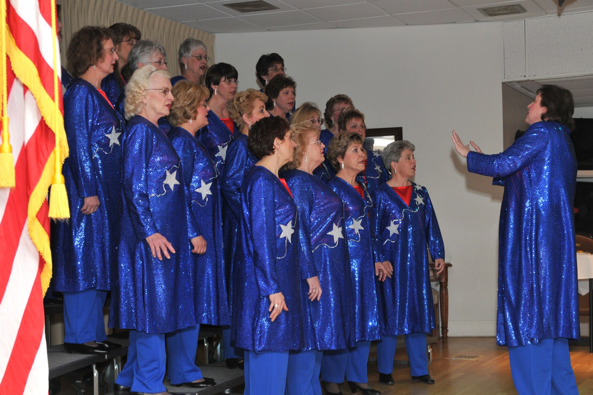 Members of the Top of the Falls Chorus, formerly the Sweet Adelines, perform during intermission at the retiree appreciation dinner. The group performed eight numbers opening with The Star Spangled Banner and closing with God Bless America. (U.S. Air Force photo/John Turner)