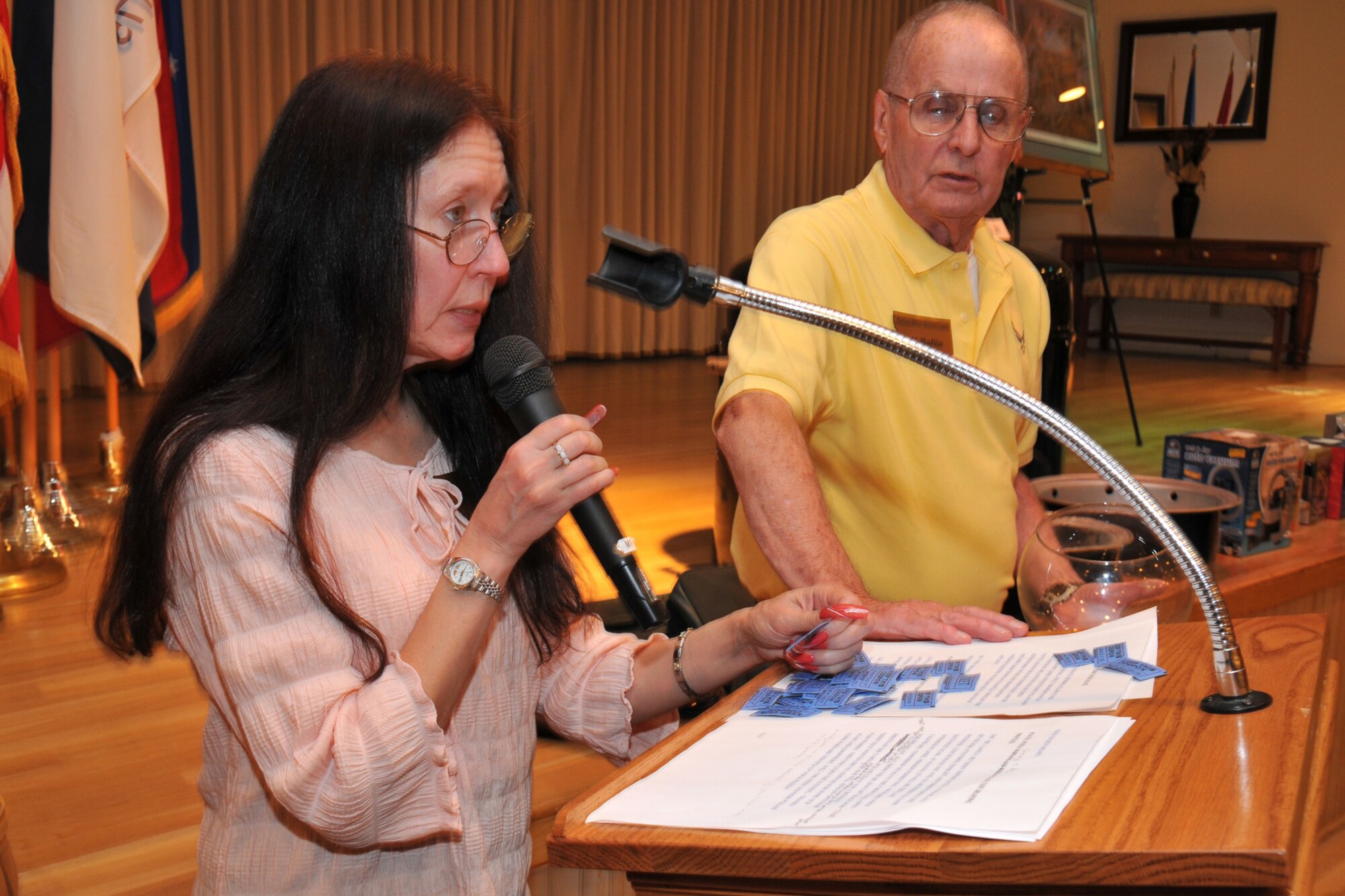 Montana Military Retiree Council members Mary Ann Mackall and retired Senior Master Sgt. Al Maflin, call ticket numbers for door prizes during the Retiree Appreciation Dinner April 26. Prizes were donated by the council, as well as by 1st Liberty Federal Credit Union, the base exchange and commissary and the 341st Services Squadron. (U.S. Air Force photo/John Turner)