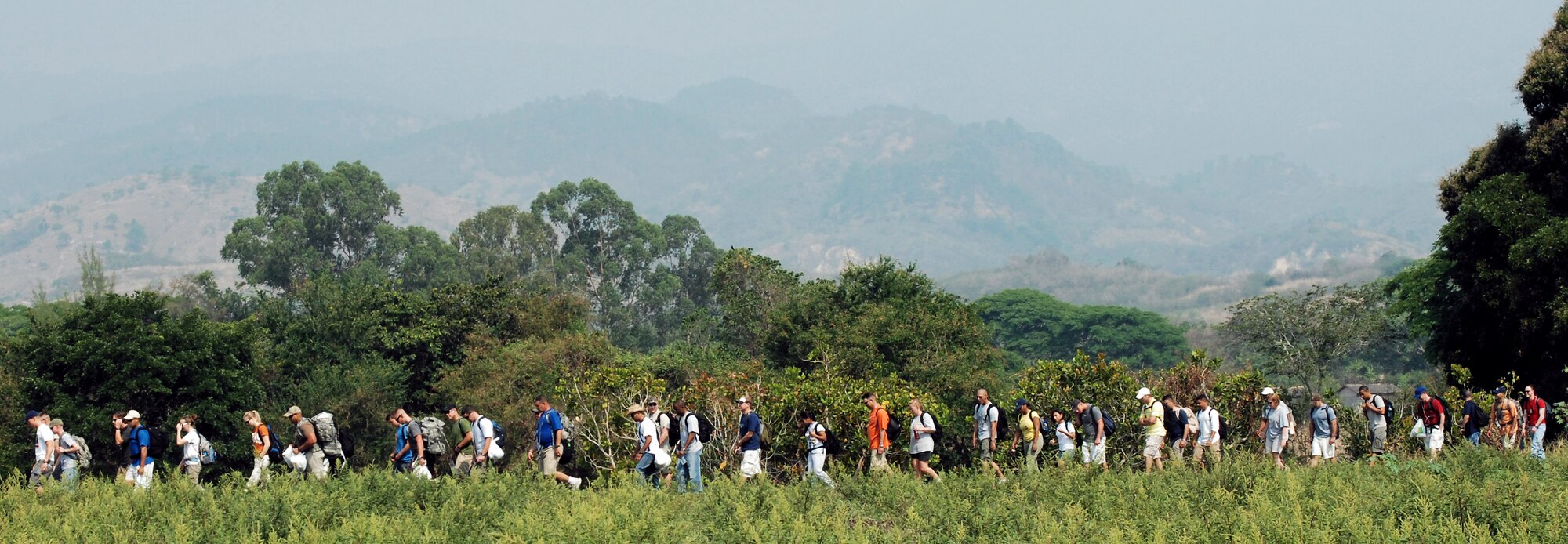 Joint Task Force-Bravo personnel hike through a field on their way to deliver food to a village near Humuya, Honduras, April 26 as part of the chapel hike program. About two and one half tons of staple food items were delivered to Honduran families in need. (U.S. Air Force photo/1st Lt. Erika Yepsen) 