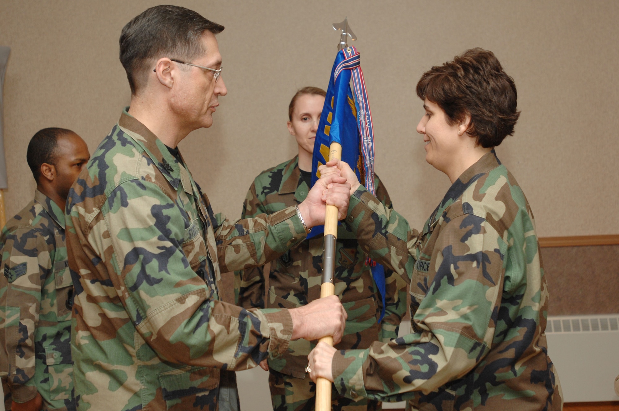 354th Mission Support Group Commander Col. John Stutts passes the guidon to 354th Force Support Squadron Commander Maj. Catherine McGowan during the squadron's activation ceremony at Eielson Air Force Base, Alaska, April 29, 2008.  The 354th Services Squadron and the 354th Mission Support Squadron merged to make the 354 FSS.  (U.S. Air Force photo/Staff Sgt. Tia Schroeder)