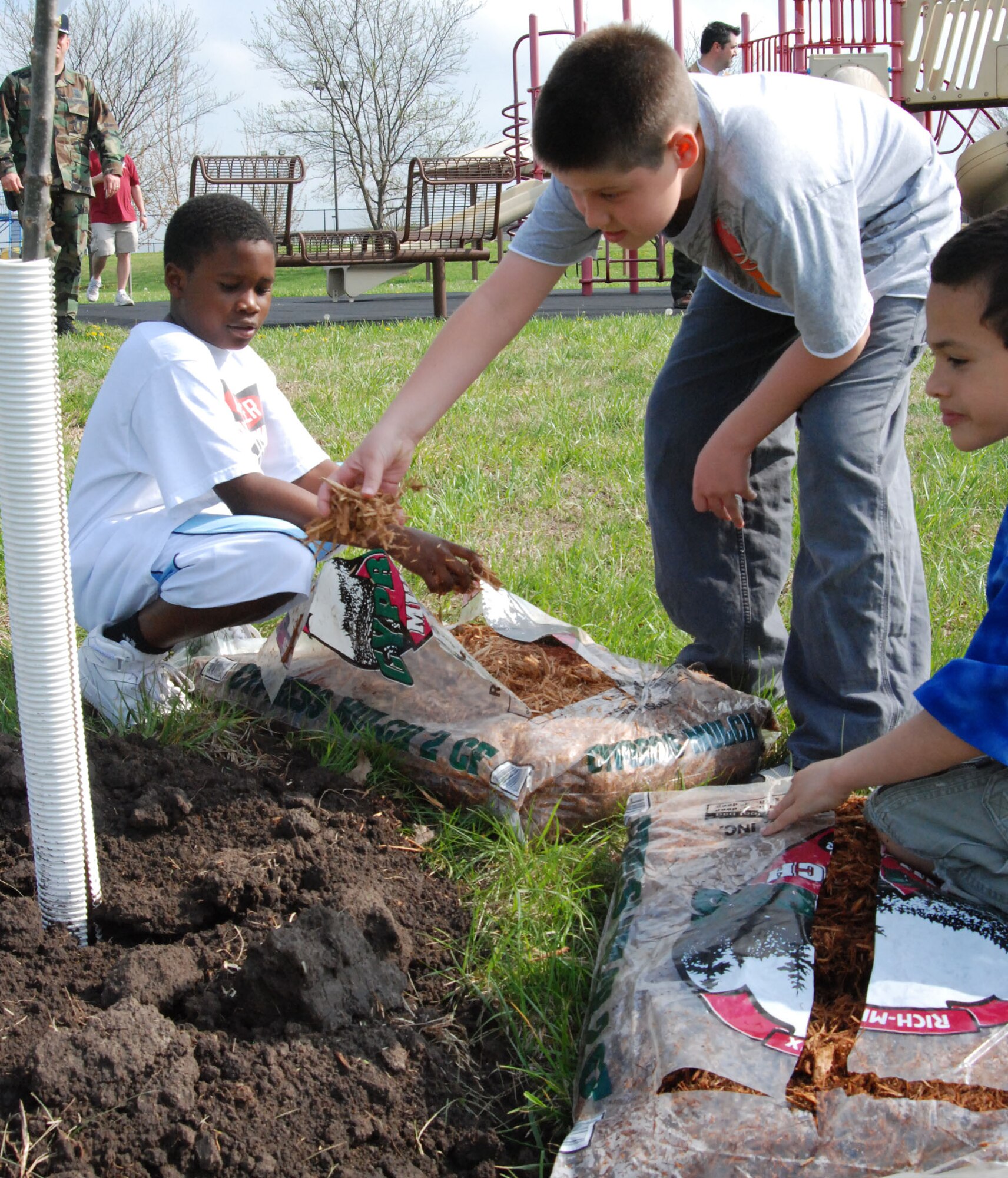 MCCONNELL AIR FORCE BASE, Kan. –Team  McConnell youths help plant Elm, Maple, and Oak trees near the base’s main pavilion during an Arbor Day Ceremony, April 24. (photo by Airman 1st Class Jessica Lockoski)  