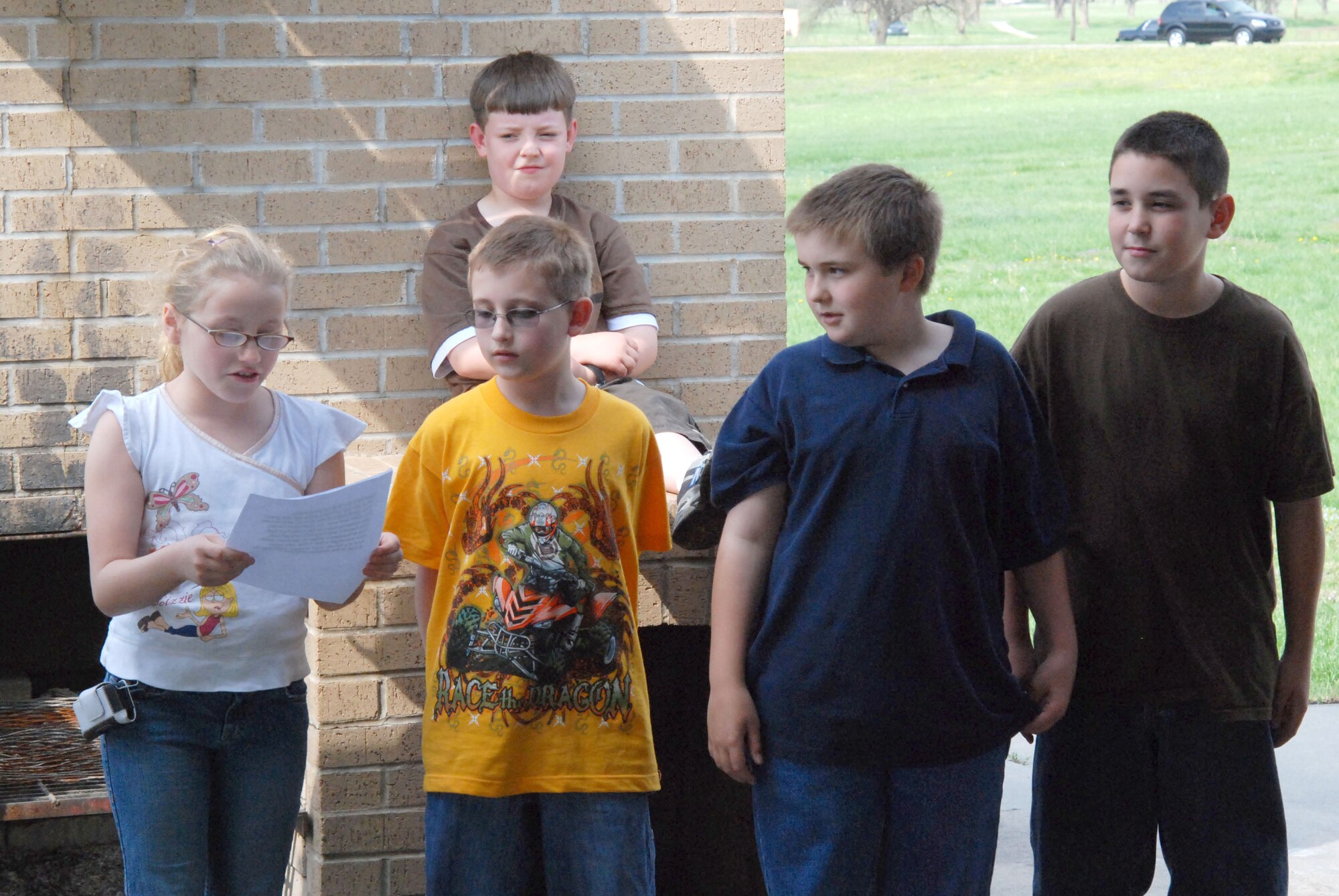 MCCONNELL AIR FORCE BASE, Kan. – Students from Oaklawn Elementary School, Wichita, Kan. read a poem they wrote for McConnell Air Force Base’s Arbor Day Ceremony, April 24 at the base’s main pavilion. They explained how planting trees keep the world green and eco-friendly. (photo by Airman 1st Class Jessica Lockoski)  
