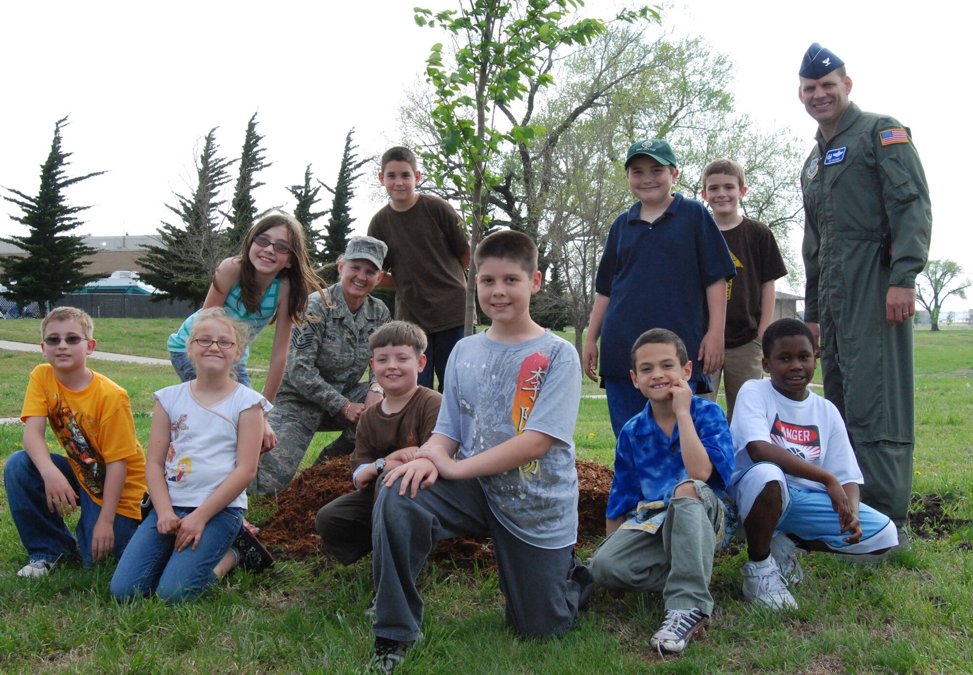 MCCONNELL AIR FORCE BASE, Kan. – McConnell youth and students from Oaklawn Elementary School, Wichita, Kan., Col. James Vechery, 22nd Air Refueling Wing commander and Chief Master Sgt. Peggy Savage, command chief,  gather nearby a freshly planted tree, April 24, during a base Arbor Day Ceremony. (photo by Airman 1st Class Jessica Lockoski)  