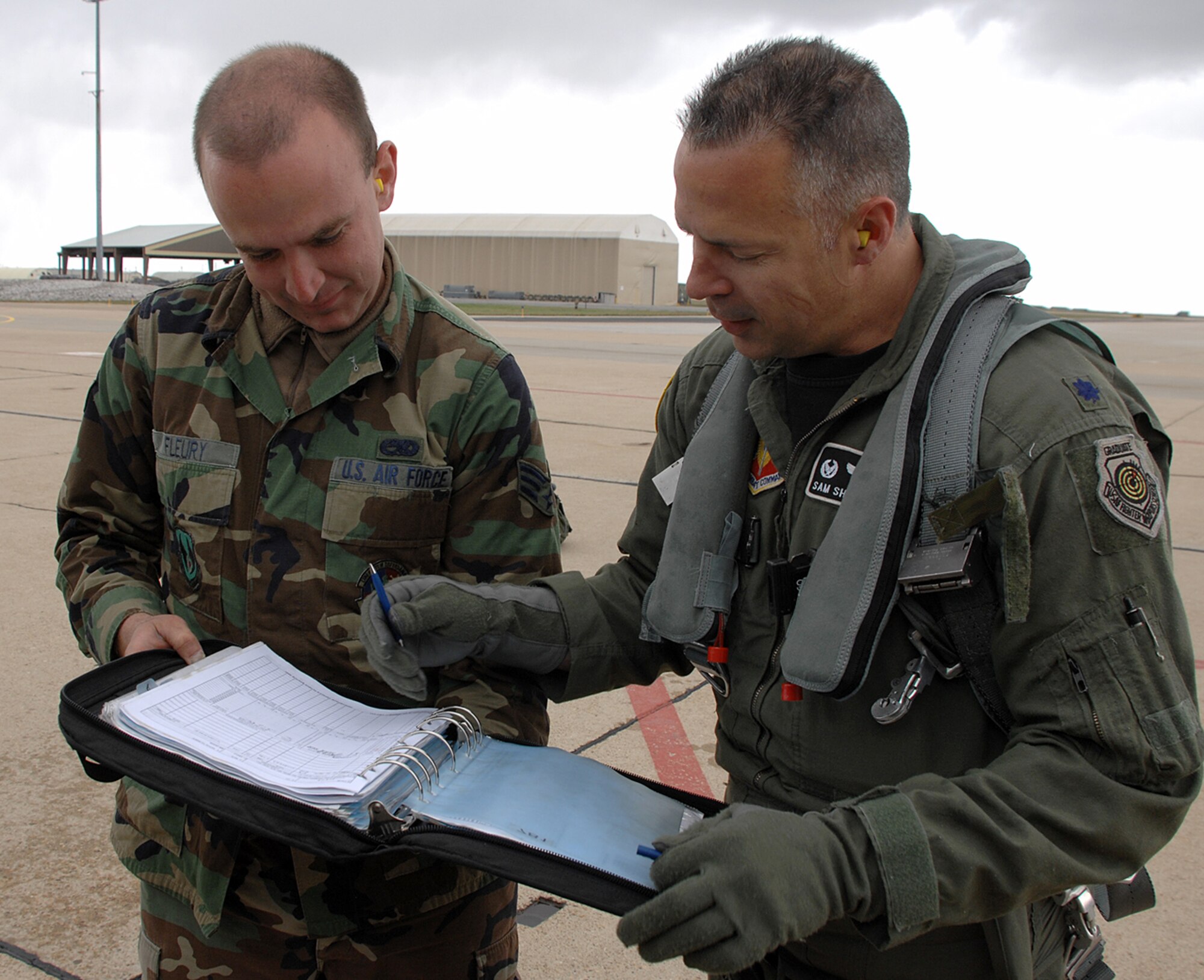 Lt. Col. Sam Shaneyfelt, 85th Test and Evaluation commander, signs the log book to make it offical after reaching the 3,000 hour mark in the skies over Hill Air Force Base, Utah.  The colonel was unaware he had reached the milestone.  He becomes only the 139th Air Force pilot to reach 3,000 hours in an F-16.  Photo by Alex R. Lloyd.

