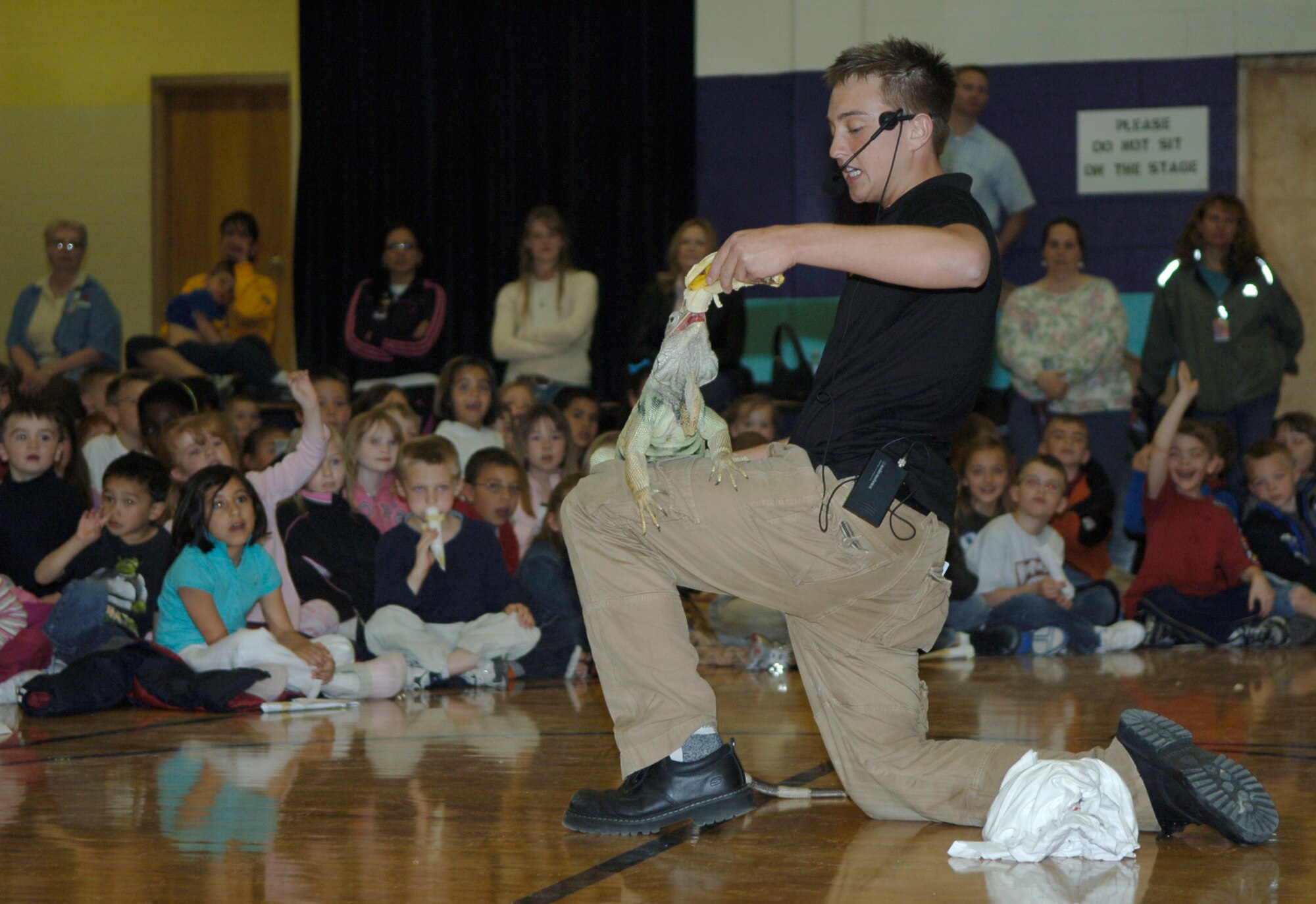 MOUNTAIN HOME AIR FORCE BASE, Idaho -- Corbin Maxey, The Reptile Guy, introduces students from the Base Primary School to Scooter, a white lizard, during Science Day at Stephensen Middle School April 25. The Mountain Home Air Force Base Parent Teacher Partnership hosted Science Day to introduce students from kindergarten through fourth grade to the world of science. (U.S. Air Force photo/Airman 1st Class Samantha S. Crane)