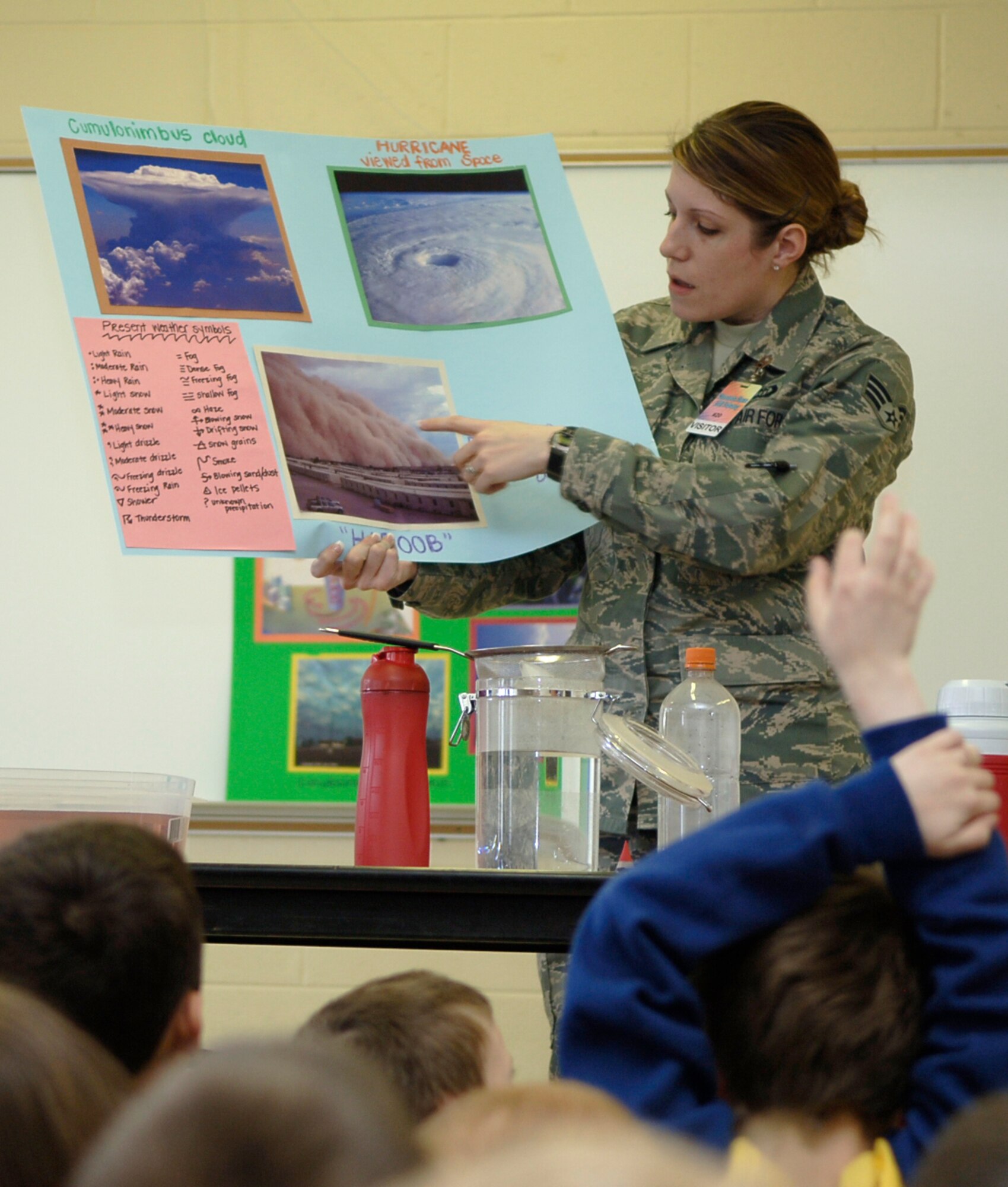 MOUNTAIN HOME AIR FORCE BASE, Idaho -- Staff Sgt. Kassandra Seymour, 366th Operations Support Squadron weather flight, explains what causes different types of weather to occur to first graders from the Base Primary School during Science Day at Stephensen Middle School April 25. The Mountain Home Air Force Base Parent Teacher Partnership hosted Science Day to introduce students from kindergarten through fourth grade to the world of science. (U.S. Air Force photo/Airman 1st Class Samantha S. Crane)