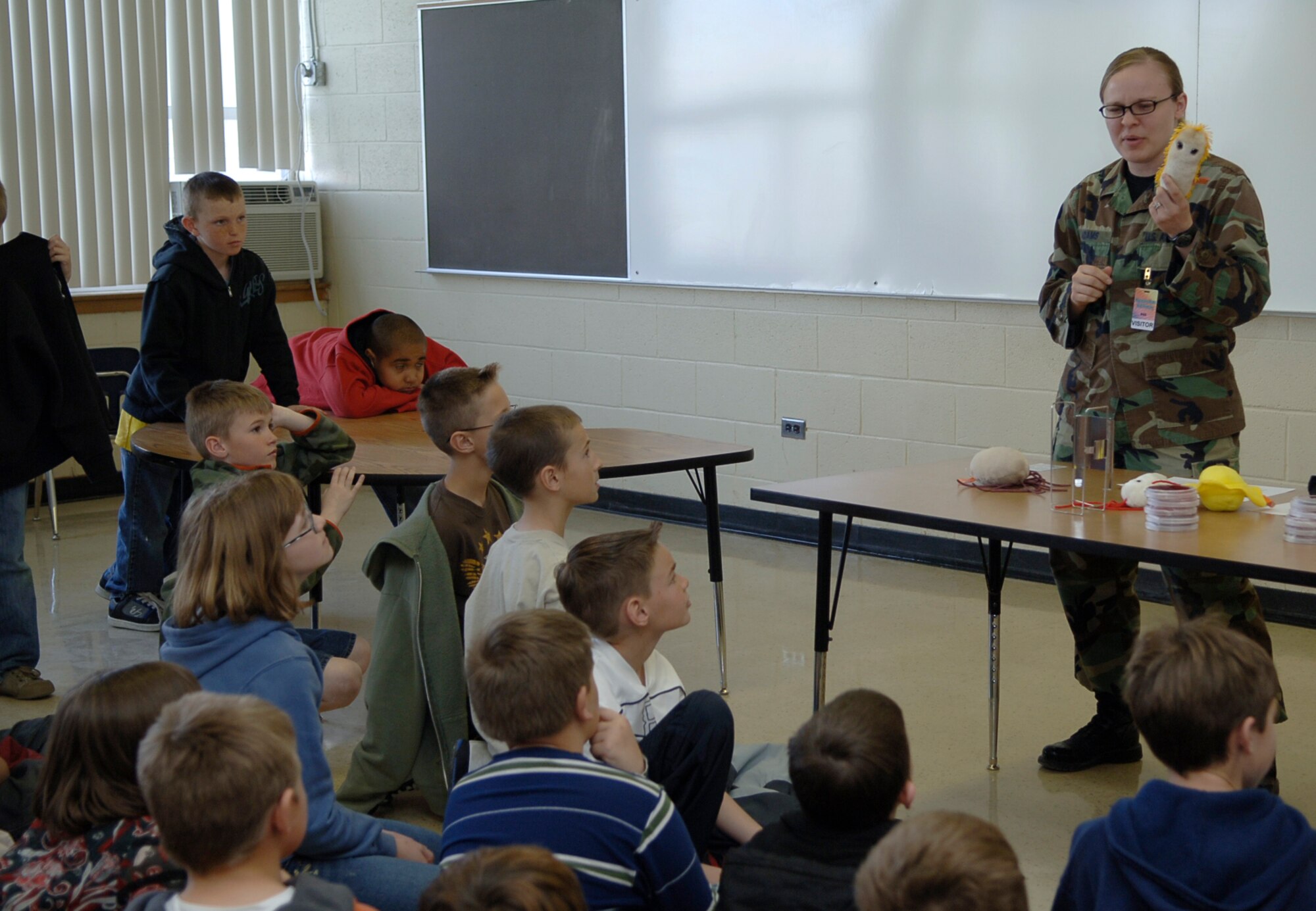 MOUNTAIN HOME AIR FORCE BASE, Idaho -- Airman Tracy Adams, 366th Aeromedical Dental Squadron Public Health technician, teaches fourth graders about different kinds of bacteria found in food during Science Day at Stephensen Middle School April 25. The Mountain Home Air Force Base Parent Teacher Partnership hosted Science Day to introduce students from kindergarten through fourth grade to the world of science. (U.S. Air Force photo/Airman 1st Class Samantha S. Crane)