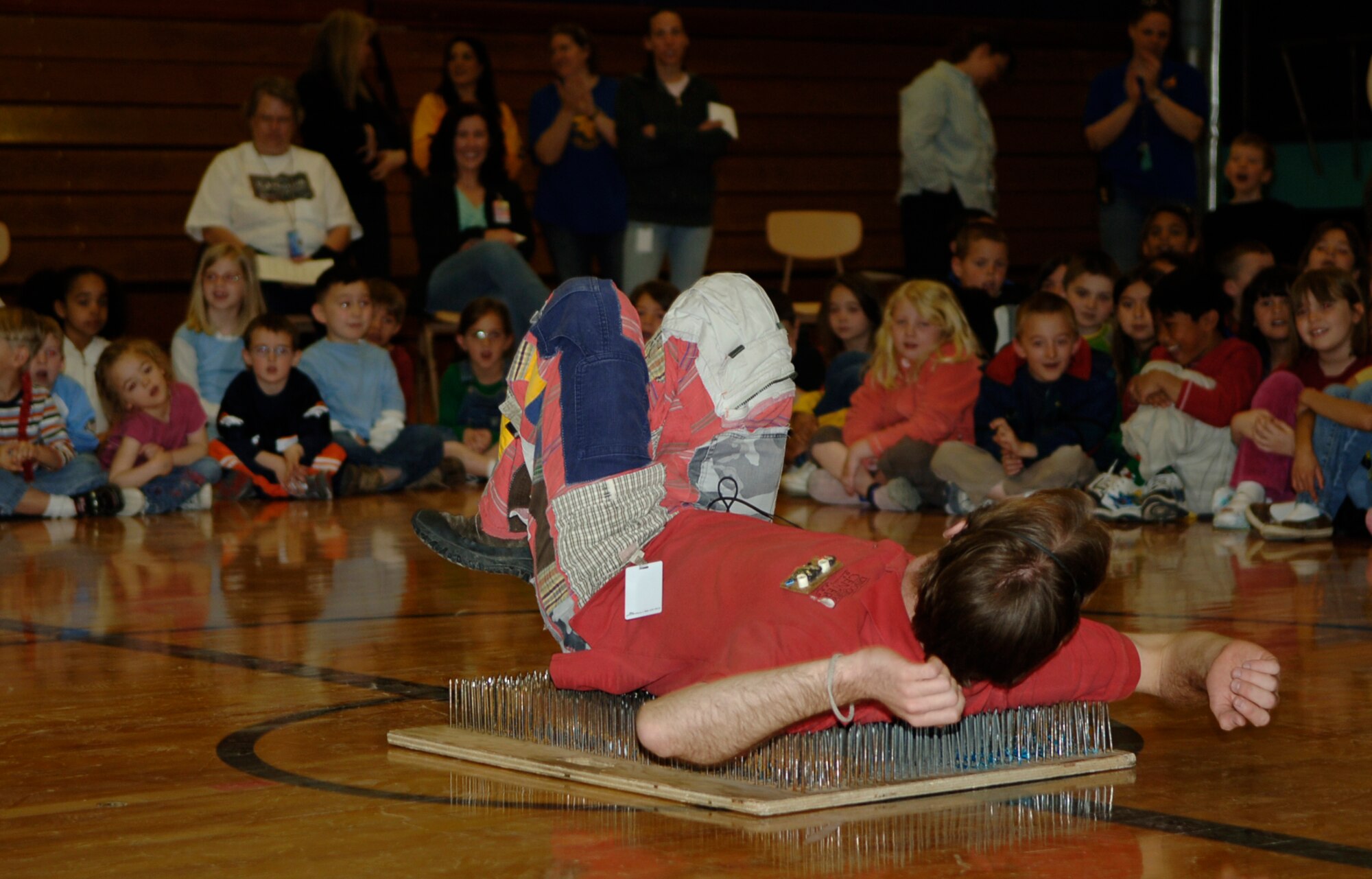 MOUNTAIN HOME AIR FORCE BASE, Idaho -- Woody Sobey, from the Discovery Center of Idaho, demonstrates how it’s possible to lie on a bed of nails by placing pressure over a large area during Science Day at Stephensen Middle School April 25. The Mountain Home Air Force Base Parent Teacher Partnership hosted Science Day to introduce students from kindergarten through fourth grade to the world of science. (U.S. Air Force photo/Airman 1st Class Samantha S. Crane)