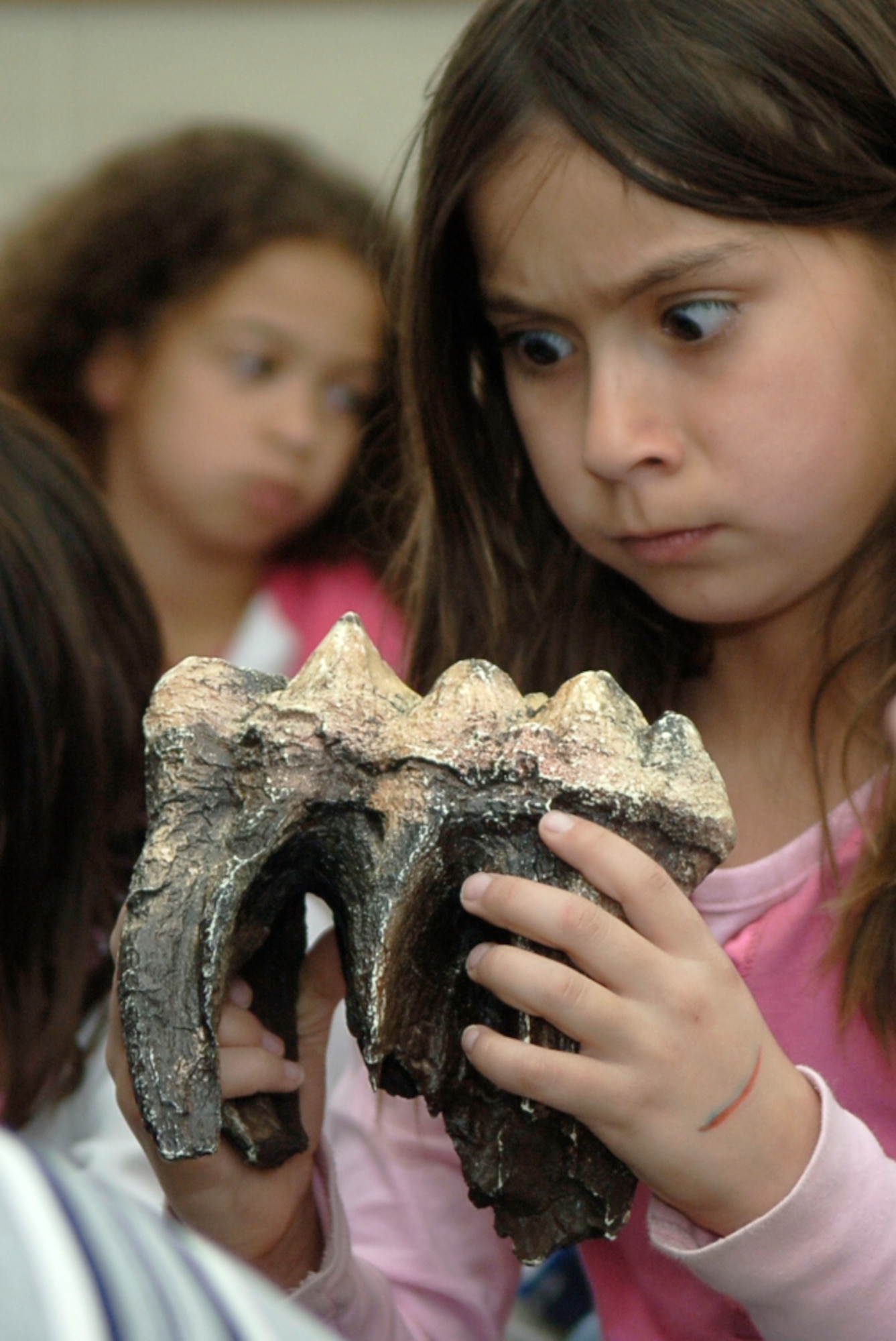 MOUNTAIN HOME AIR FORCE BASE, Idaho -- Briana Lee, a second grader from the Base Primary School, reacts to a fossil replica of an American mastodon during Science Day at Stephensen Middle School April 25. The Mountain Home Air Force Base Parent Teacher Partnership hosted Science Day to introduce students from kindergarten through fourth grade to the world of science. (U.S. Air Force photo/Airman 1st Class Samantha S. Crane)