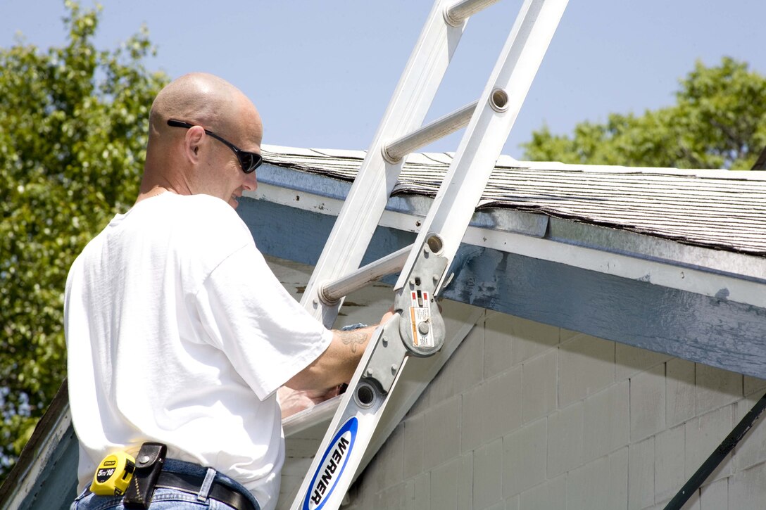 Master Sgt. Keith Fitzpatrick, the first sergeant of the 80th Flying Training Wing, works on the eave of a house April 26 in Wichita Falls, Texas, as a volunteer with Christmas in Action, a nonprofit group that helps with home repairs for low-income or disabled people. More than 100 people from Sheppard and the local area volunteered their time to repair more than 70 homes. (U.S. Air Force photo/Lt. Col. Ternell Washington) 