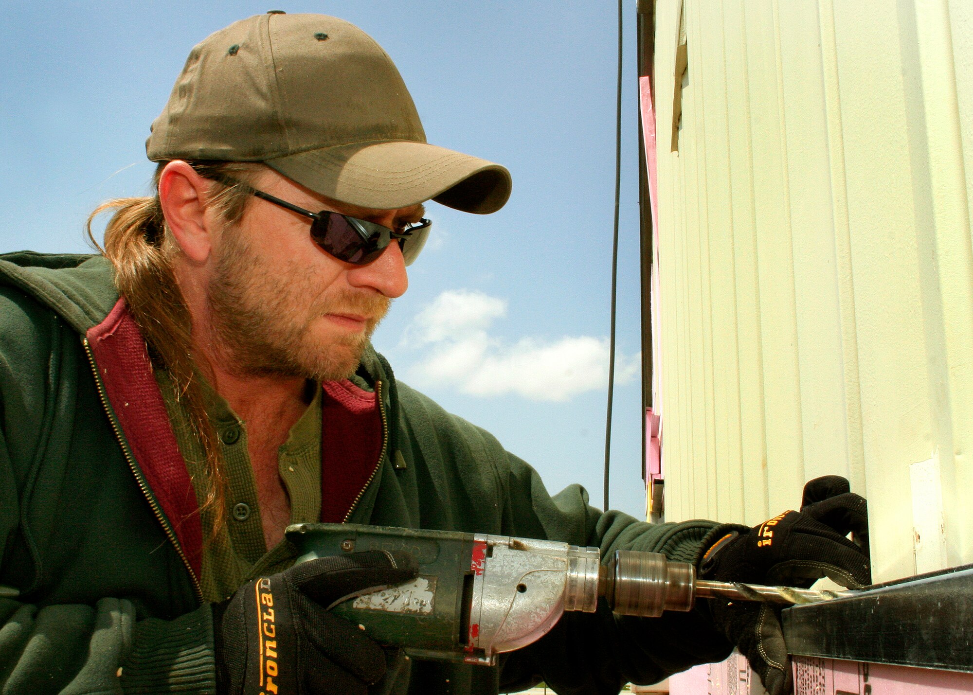 GRISSOM AIR RESERVE BASE, Ind., -- Dee Colbert of the Belco Company installs new siding on Chocks.  It is part of a major renovation that is being done to the all-ranks establishment.  (U.S. Air Force Photo/Tech. Sgt. Patrick M. Kuminecz)