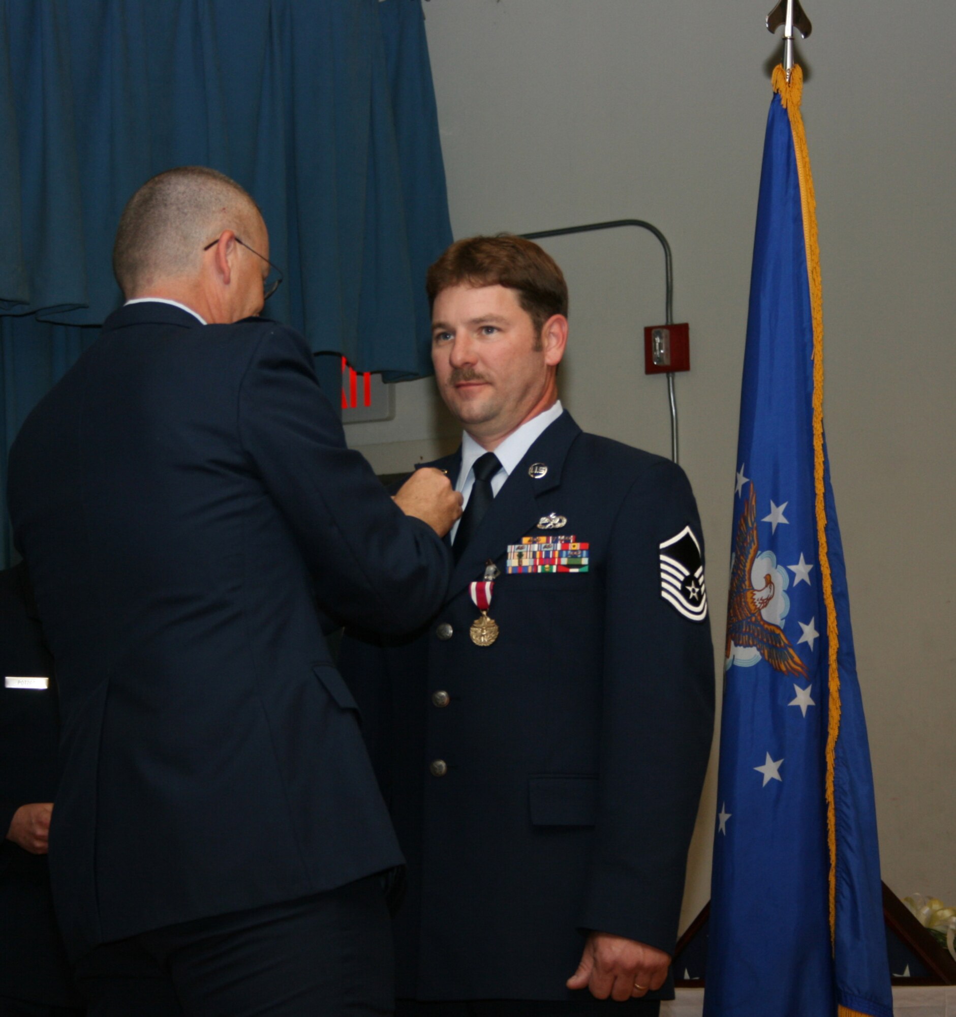 SEYMOUR JOHNSON AIR FORCE BASE, N.C. -- Master Sgt. Kenneth Brockwell (right) of the 916th Communication Squadron retires from the Air Force Reserve with 22 years of service.  Lt. Col  James Horton, 916th CS commander, pins on Sergeant Brockwell's retirement pin during a ceremony held during the April unit training assembly.