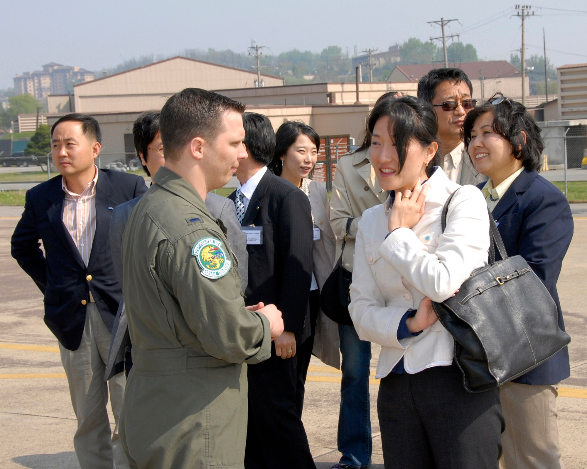 OSAN AIR BASE, Republic of Korea – Korean Young Leaders take a moment to speak with Airmen on the flightline at Osan AB during their orientation of air and space power used to defend and protect the Republic of Korea. These type visits are a testament to the ROK-US alliance.  For over the last half century, the ROK-US alliance remains resilient in the face of adversity and adaptive to the constantly changing situations in the region.  (U.S. Air Force photo/Staff Sgt. Scottie McCord)