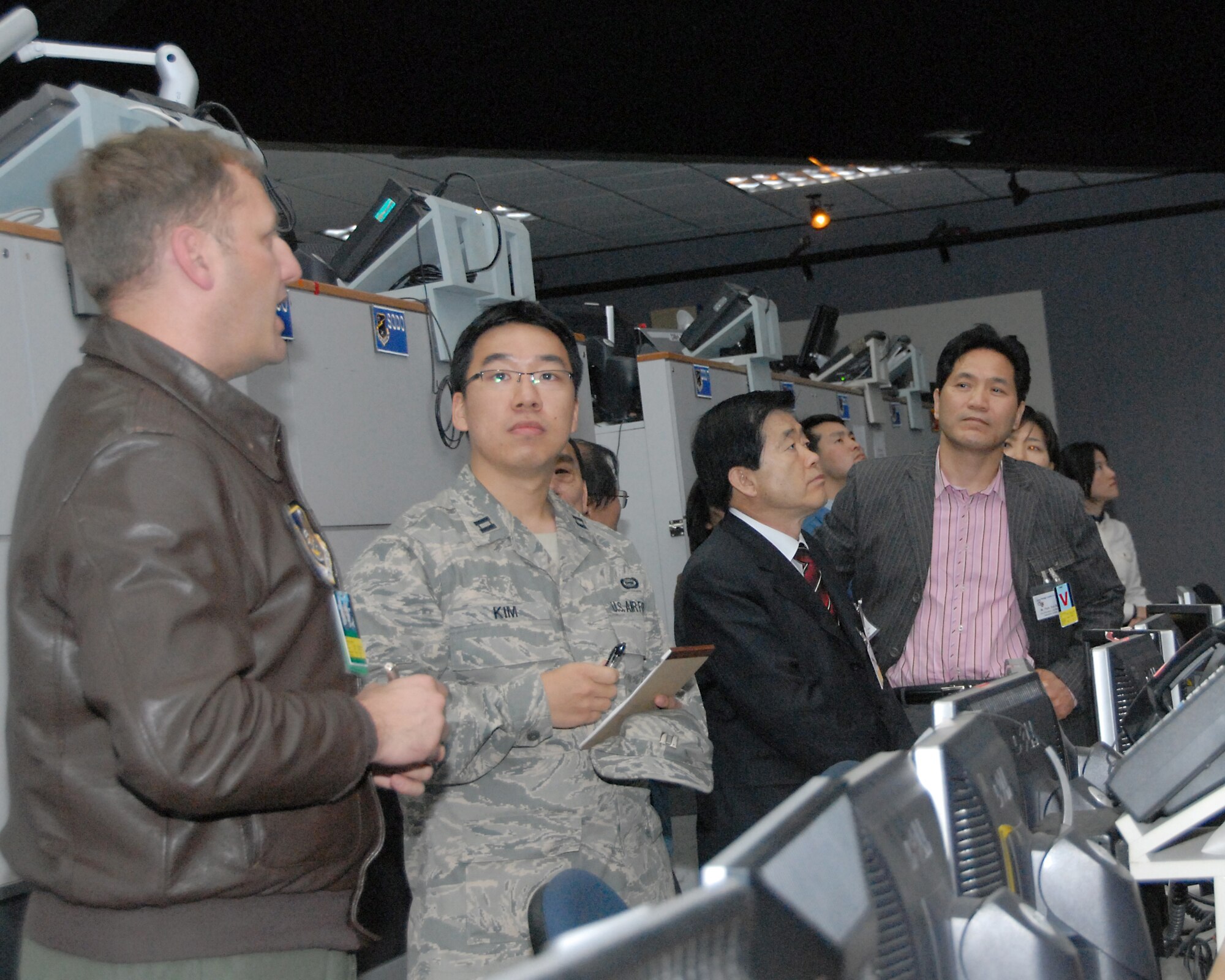 OSAN AIR BASE, Republic of Korea – Col. Rob Kyrouac (left), 607 Air and Space Operations Center chief of combat operations division, briefs Korean Young Leaders on the “pit floor” of the Korean Air Operations Center – airpower hub for defending and deterring war against the Republic of Korea. These type visits are a testament to the ROK-US alliance.  For over the last half century, the ROK-US alliance remains resilient in the face of adversity and adaptive to the constantly changing situations in the region.  (U.S. Air Force photo/Staff Sgt. Lakisha Croley)