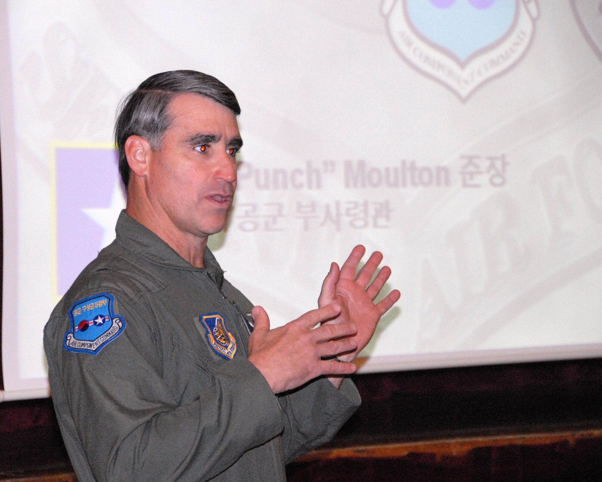 OSAN AIR BASE, Republic of Korea – Brig. Gen. Punch Moulton, Seventh Air Force vice commander, briefs a delegation of 73 young leaders from the Republic of Korea; part of the Korea Young Leaders program. These type visits are a testament to the ROK-US alliance.  For over the last half century, the ROK-US alliance remains resilient in the face of adversity and adaptive to the constantly changing situations in the region.  (U.S. Air Force photo/Staff Sgt. Lakisha Croley)