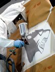 Kunsan Air Base, Republic of Korea –  Senior Airman Brian Sheppard, 8th Maintenance Squadron aircraft structural maintenance journeyman, paints the last “WP” emblem onto one of the last F-16 that the base received here April 30. The F-16 was flown from Eielson Air Force Base Alaska. The 8th Maintenance Squadron turned over 24 jets in a two month time period. (U.S. Air Force photo/Senior Airman Dana D. Hill) 