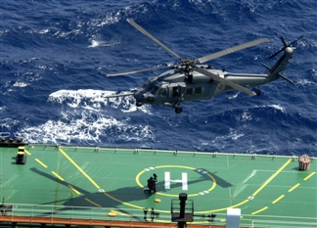 A U.S. Air Force HH-60G Pave Hawk picks up a pararescueman and a survivor off a ship about 260 miles south of New Orleans during a rescue mission, April 25, 2008. Responding to a U.S. Coast Guard request, the rescue team performed a 10-hour mission to retrieve Cuban migrants in distress who were picked up by a passing ship. 