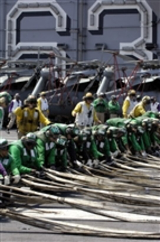 USS Kitty Hawk (CV-63) Air Department sailors raise an aircraft barricade during flight deck drills while underway near Yokosuka, Japan, on April 18, 2008.  Aircraft barricades are used to help land damaged aircraft onto the ship safely.  The Kitty Hawk is on its last deployment before it is relieved by the USS George Washington (CVN-73) this summer.  