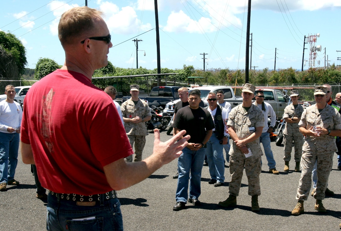 Chief Warrant Officer-3 Ronald Granneman, chemical, biological, radiological, and nuclear defense officer in charge, explains motorcycle safety and precautionary measures for the first ride of the Ride Safe Club at Building 600 August 1 here.  In the past year there have been at least 19 Marine fatalities due to motorcycle accidents. To prevent more fatalities, Granneman and Sgt. Robert Manion, training's nuclear, biological and chemical defense chief, founded the "Ride Safe Program."  "The program is designed to mentor younger Marines and empower noncommissioned officers to give guidance," Granneman said. "It will touch on riding skills, safety, maintenance, personal protective equipment and increase situational awareness for riders."  Granneman said the club plans to meet twice a month. The first meeting will be prior to a ride, to oversee the routes that will be taken, and the second meeting is planned to be the group ride.  "The first ride was a great day and I got a lot of positive feedback from the riders," Granneman said.  He encourages riders and non-riders to participate in the meetings.  There are no stipulations on bikes or individuals. The club is open to all motor vehicles with two wheels and all-terrain vehicles. For more information on the "Ride Safe Club," please contact Granneman at 477-8674 or Manion at 477-8355.