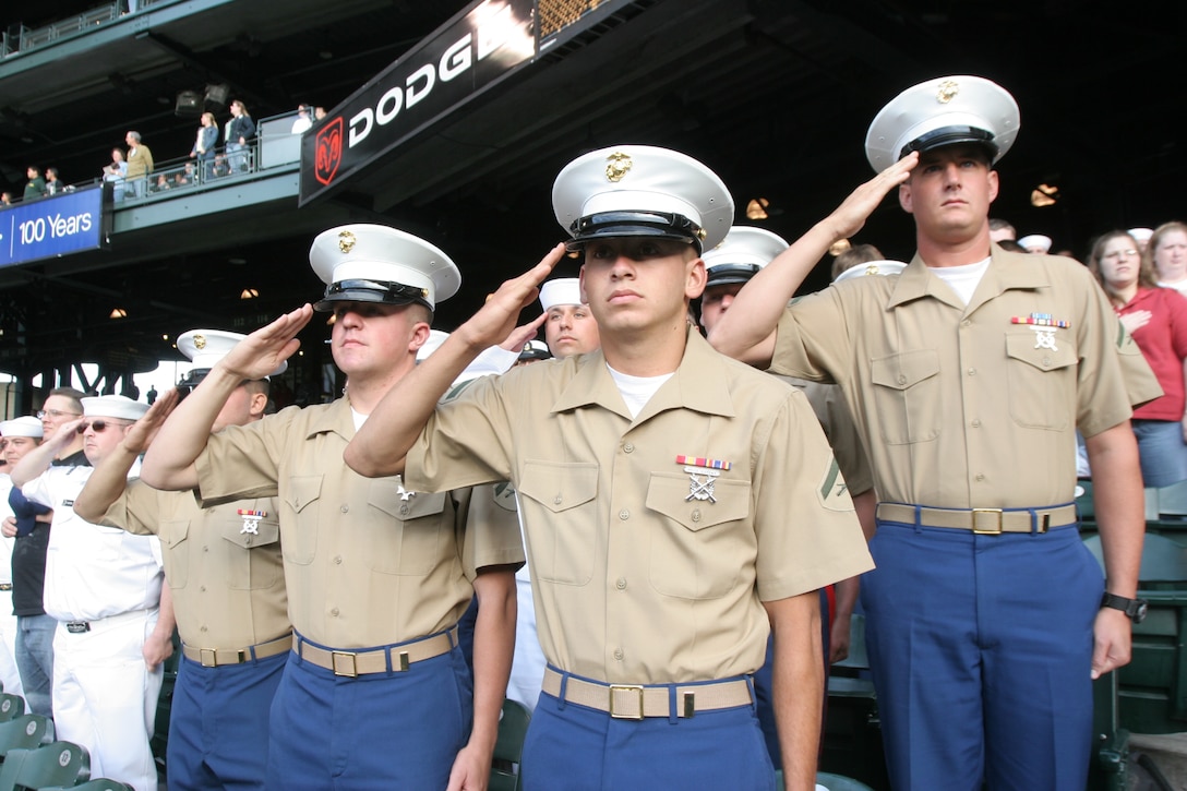 Marines from 3rd Assault Amphibian Battalion, Camp Pendleton, Calif., salute the flag during the playing of the national anthem at Safeco Field in Seattle, Wash., Aug 1. The Marines attended the game while in town to take part in Fleetweek which is part of the city’s summer celebration Seafair.::r::::n::