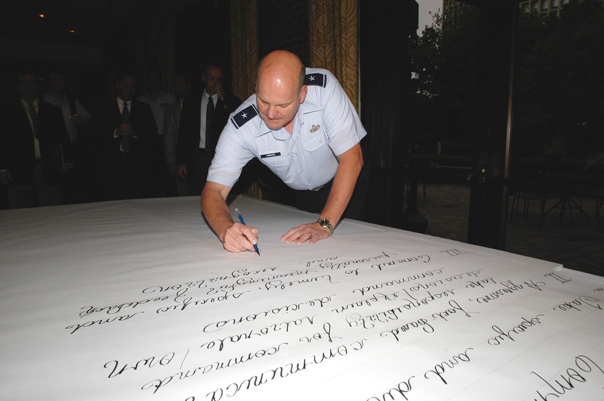 Brigadier General Dana Simmons, Air Force Office of Special Investigations commander, signs a proclaimation. Modeled after the Declaration of Independence, the proclaimation resolves to find better solutions for "Work - Life - Balance" issues such as the compensation system, heavy workloads, organizational frustrations, time spent with family, clear direction, fear of punishment, the AFOSI culture and communications. (U.S. Air Force photo/Tech. Sgt. John Jung)