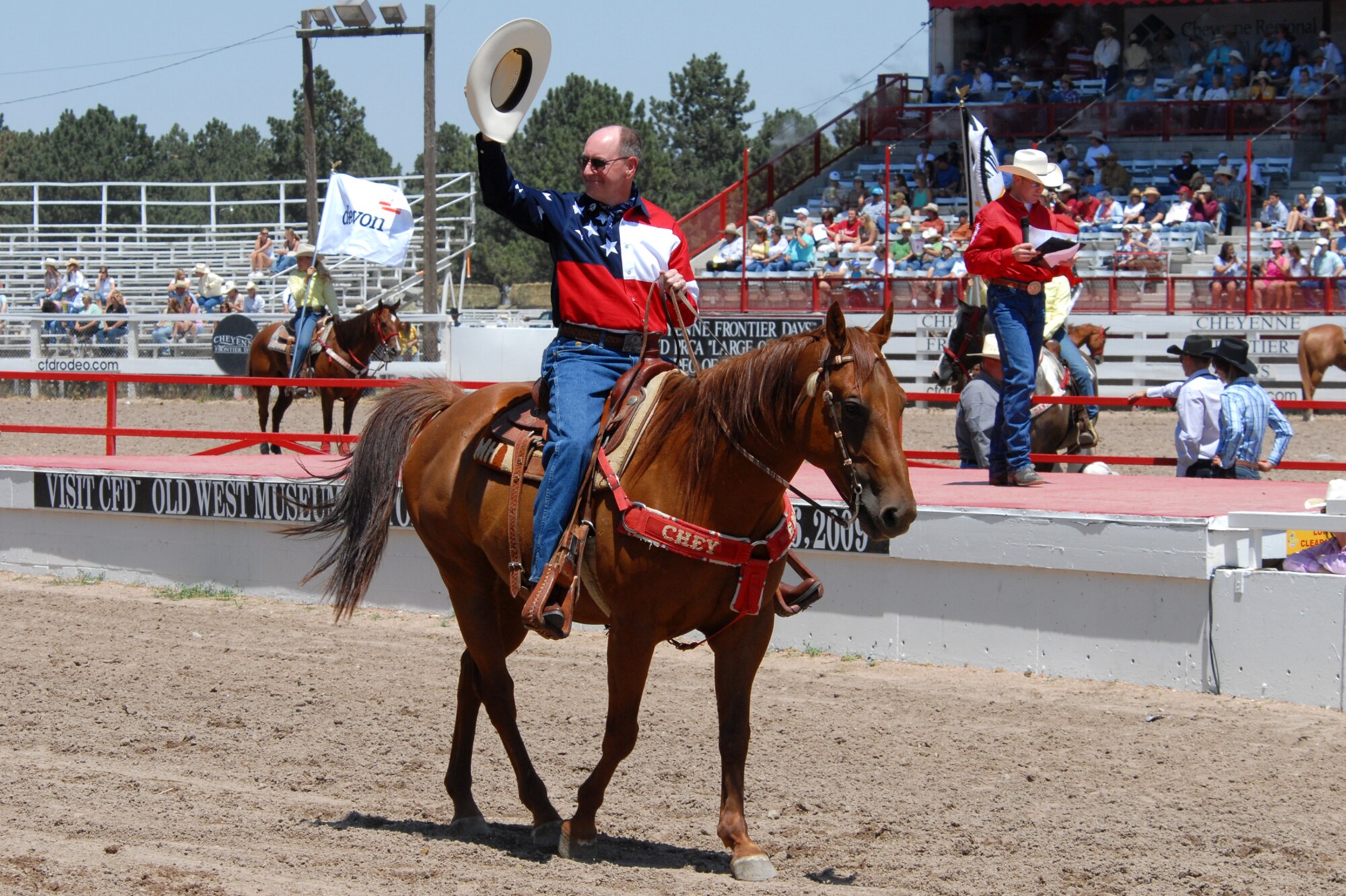 Gen. Robert Kehler, Air Force Space Command commander, waves to rodeo fans as he rides horseback during a Cheyenne Frontier Days rodeo July 19. General Kehler also toured Warren’s Fort D.A. Russell Days and was the Grand Marshall for a CFD parade during his visit (Photo by Berni Ernst).