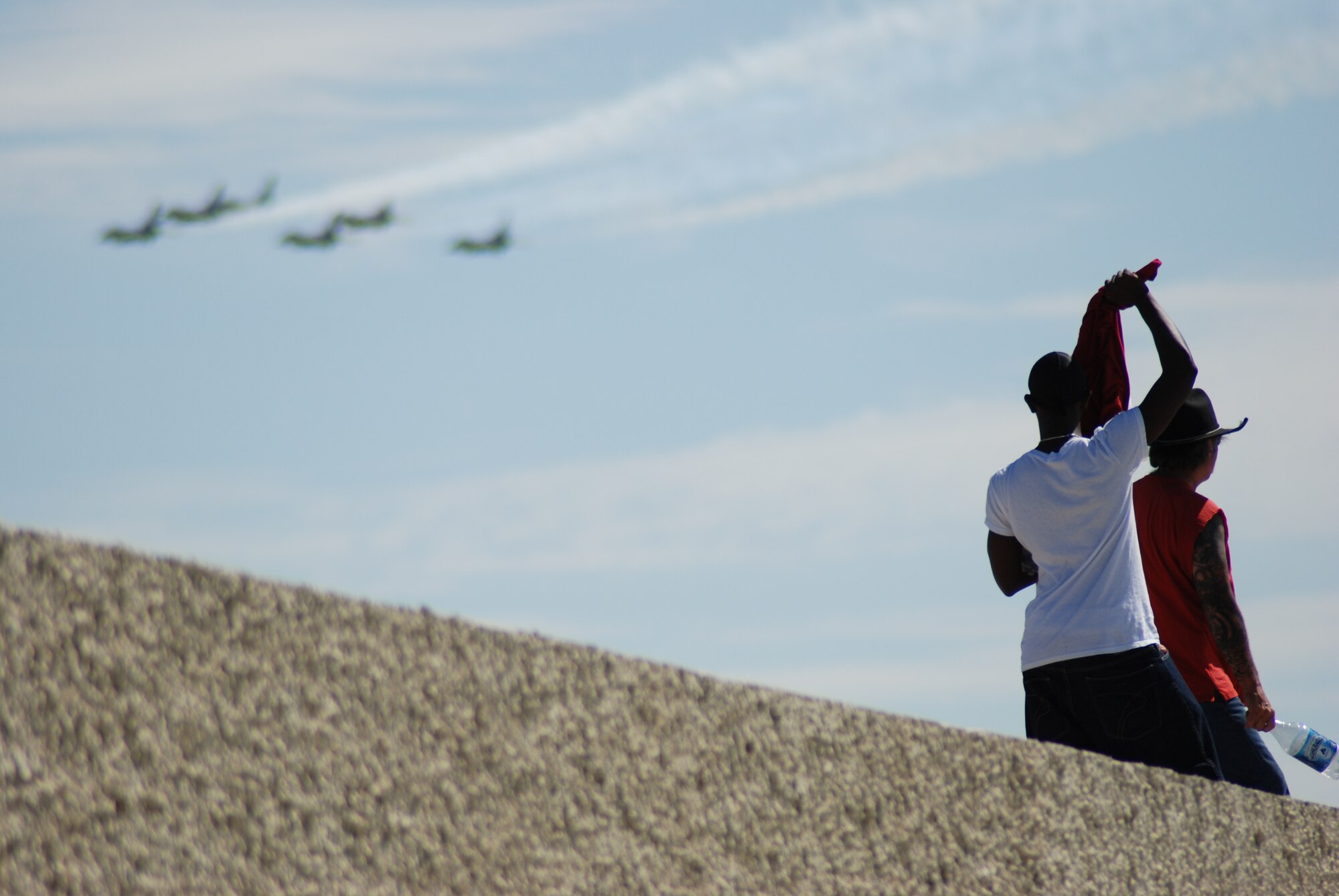 Two volunteers stand atop LCCC and observe a Thunderbird formation (Photo by Airman 1st Class Daryl Knee).