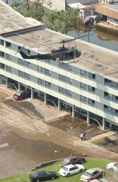 Utilizing the rescue crane in their UH-1 "Air Ambulance", members of the 832nd Medical Company from West Bend, Wisconsin prepare to hoist a Hurricane Katrina survivor from an apartment building completely surrounded by flood waters. The Hurricane made landfall near Buras, Louisiana on August 29th 2005 with winds up to 230km/h and by the following day had broken two New Orleans levees covering 80 percent of the city with water from nearby Lake Pontchartrain.
(US Air National Guard Photo by TSgt Paul Gorman) (Released by MAJ Ed Bush, 102nd PAD)
