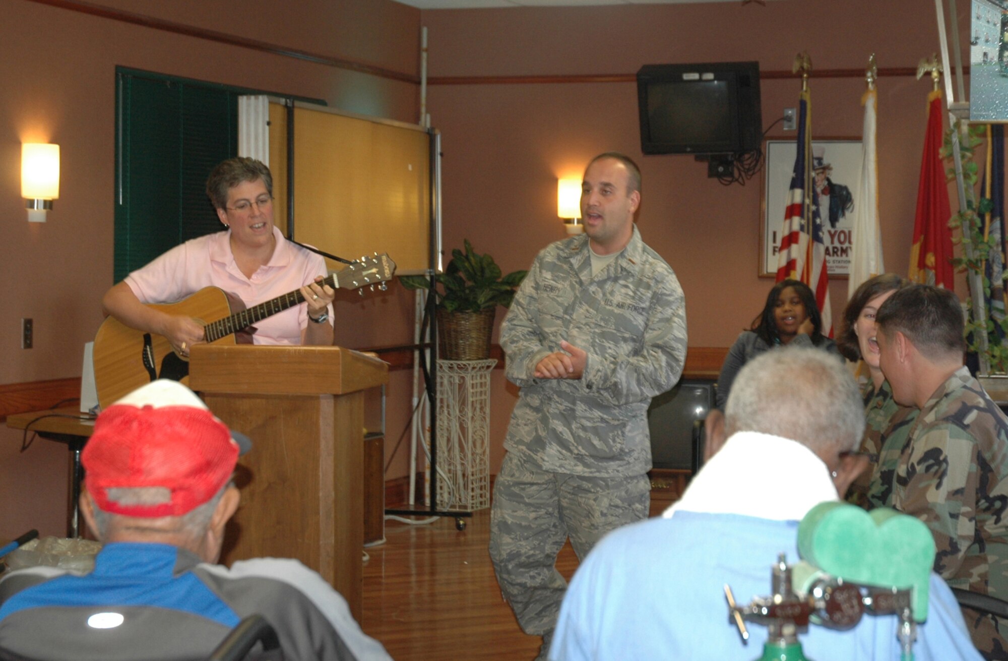 Second Lt. Matt Henry and Susan Storm, a hospice palietive care social worker, sings hymns to a group of veterans at the Ralph H. Johnson Veterans Administration Medical Center.  The VA medical center was one of many stops on the chaplain candidate tour of Charleston, S.C.