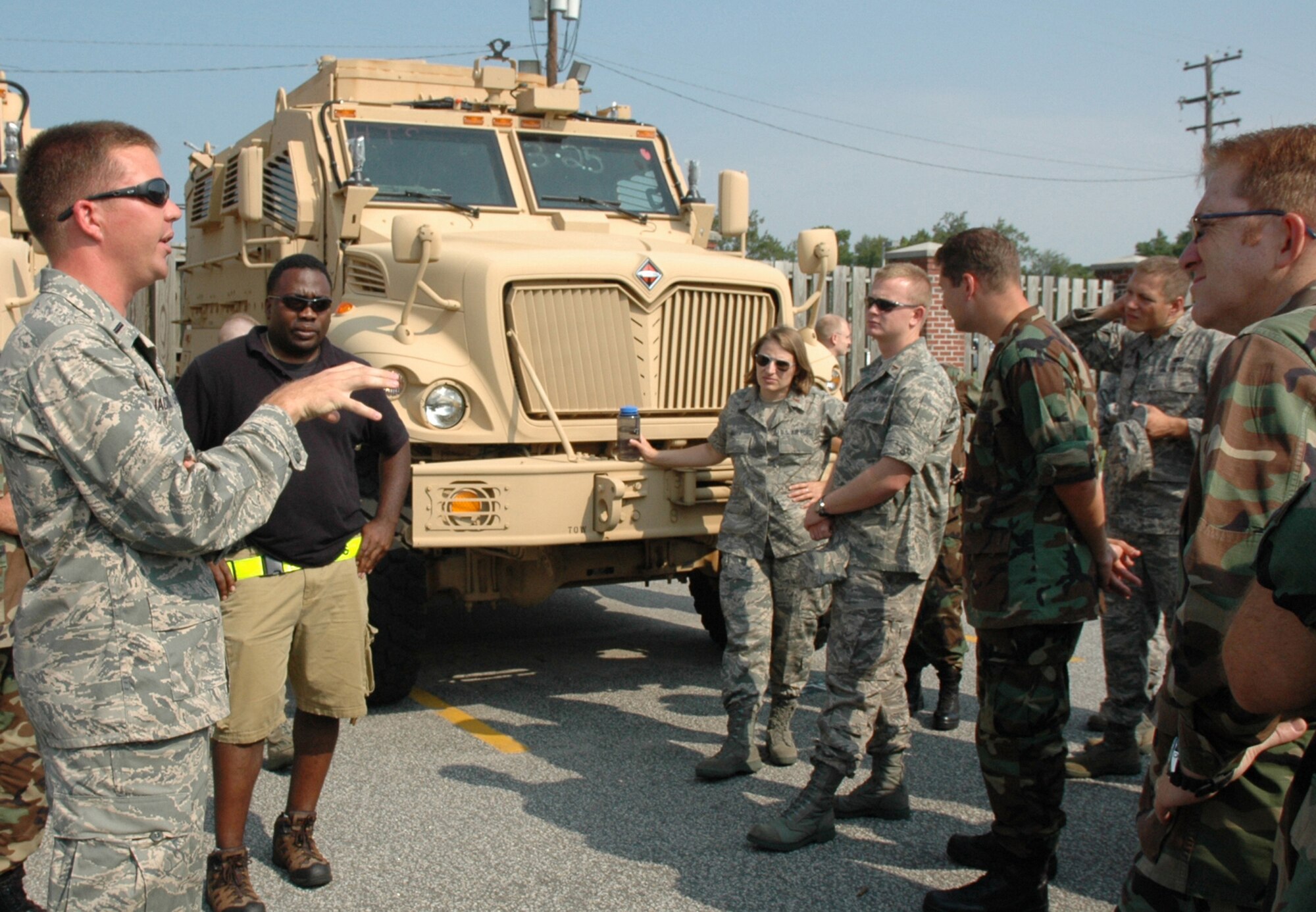 First Lt. Chris Jacobson, 437th Aerial Port Squadron (left), discusses mine-resistant, ambush-protected vehicles to a group of chaplain candidates July 31, 2008.  The candidates spent four days at Charleston Air Force Base, S.C., learning about the Air Force. (U.S. Air Force photo/Tanya Trejo)
