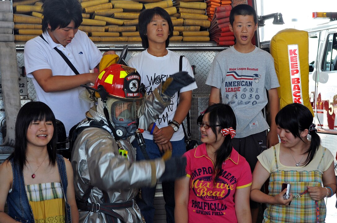 ELLSWORTH AIR FORCE BASE, S.D. -- Tech. Sgt. David Ross, 28th Civil Engineer Squadron crew chief, displays firefighting equipment and vehicles to high school students from Nikko City, Japan here, July 30. The students are involved with a nonprofit diplomacy network that creates and strengthens partnerships between the United States and international communities. (US Air Force Photo/Airman 1st Class Adam Grant)