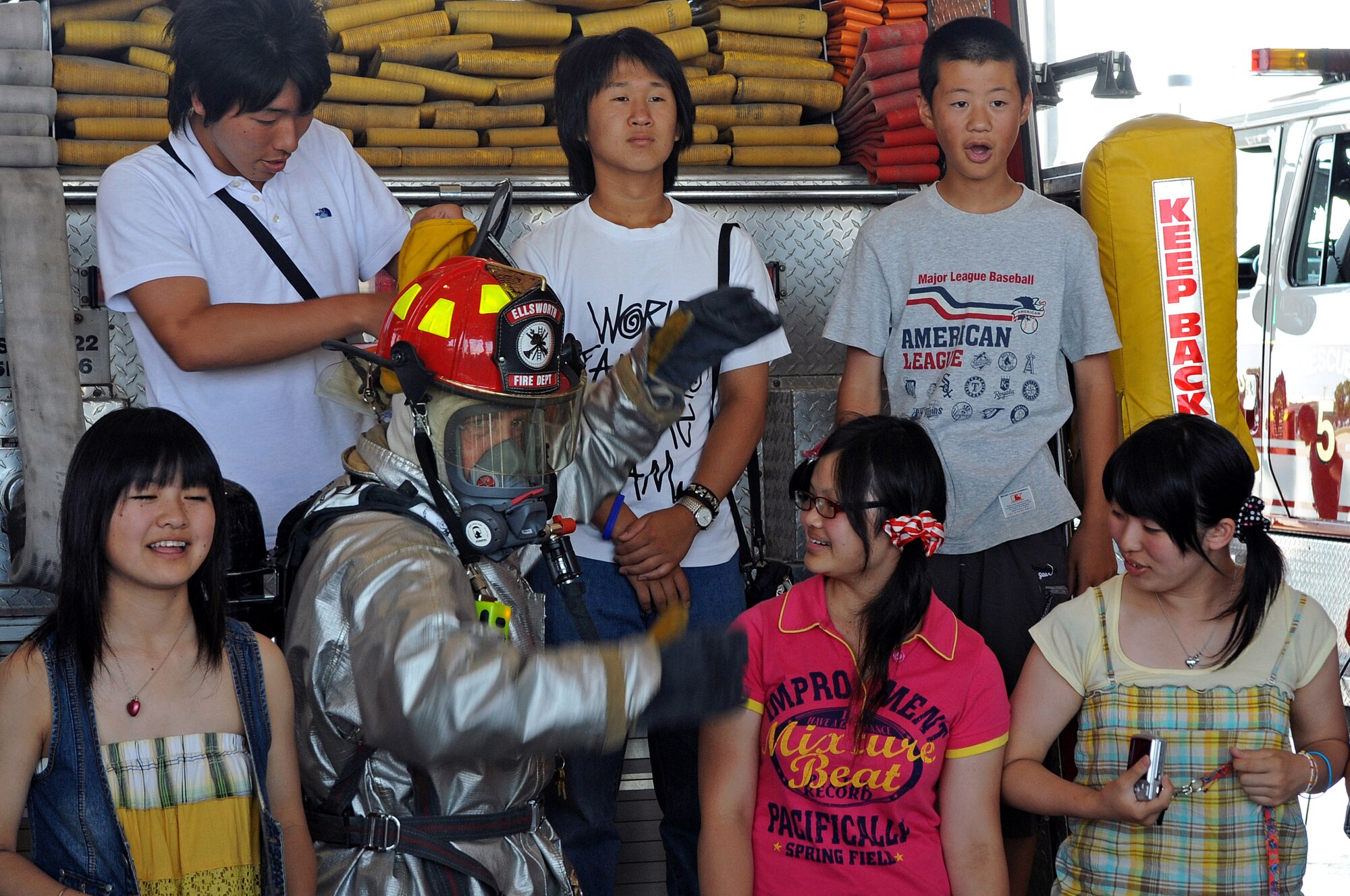 ELLSWORTH AIR FORCE BASE, S.D. -- Tech. Sgt. David Ross, 28th Civil Engineer Squadron crew chief, displays firefighting equipment and vehicles to high school students from Nikko City, Japan here, July 30. The students are involved with a nonprofit diplomacy network that creates and strengthens partnerships between the United States and international communities. (US Air Force Photo/Airman 1st Class Adam Grant)