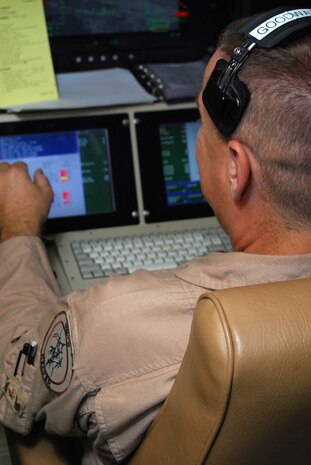 JOINT BASE BALAD, Iraq -- Senior Master Sgt. Ralph Goodwater watches output from MQ-9 Reaper cockpit displays during a demonstration here Aug. 1. The Reaper is designed as a hunter-killer, capable of loitering over targets for long periods of time and delivering laser-guided ordnance such as GBU-12 bombs or Hellfire missiles. Sergeant Goodwater, a Reaper sensor operator with the 46th Expeditionary Reconnaissance and Attack Squadron here, is a reservist deployed from Creech Air Force Base, Nev. (U.S. Air Force photo/Staff Sgt. Don Branum)