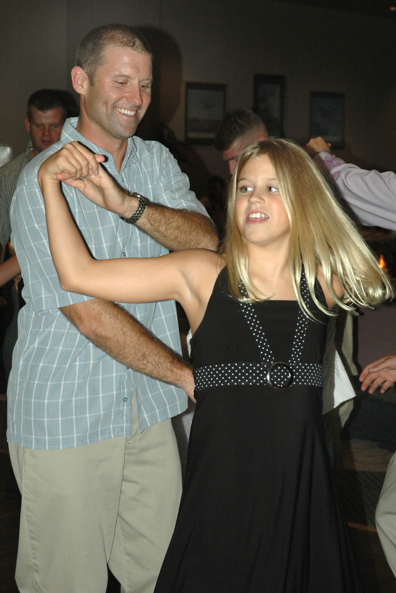 Lt. Col. Kevin Huyck, 95th Fighter Squadron commander, twirls his daughter Shanna during a swing dance at the "Daddy Daughter Dance" hosted by the 325th Services Squadron July 24. More than 50 Tyndall fathers escorted their daughters to the special event. 