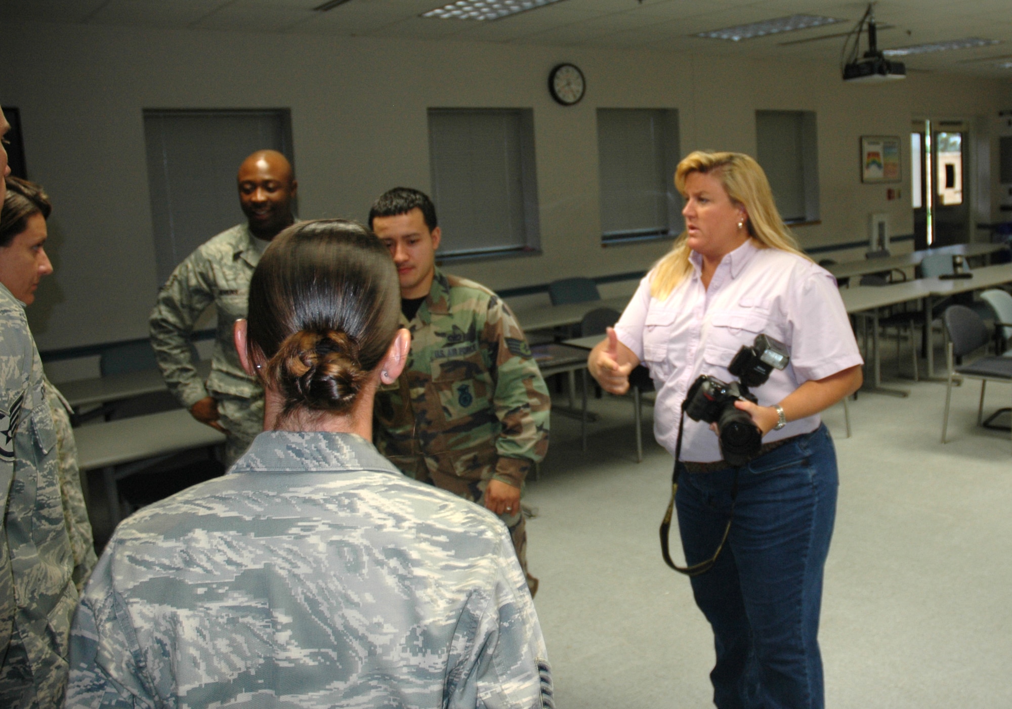 Lisa Norman, K-Mar Industries and Tyndall multimedia lead photographer and contractor, arranges some 325th Security Forces Airmen for a group photo Thursday. (U.S. Air Force photo/Staff Sgt. Timothy R. Capling)