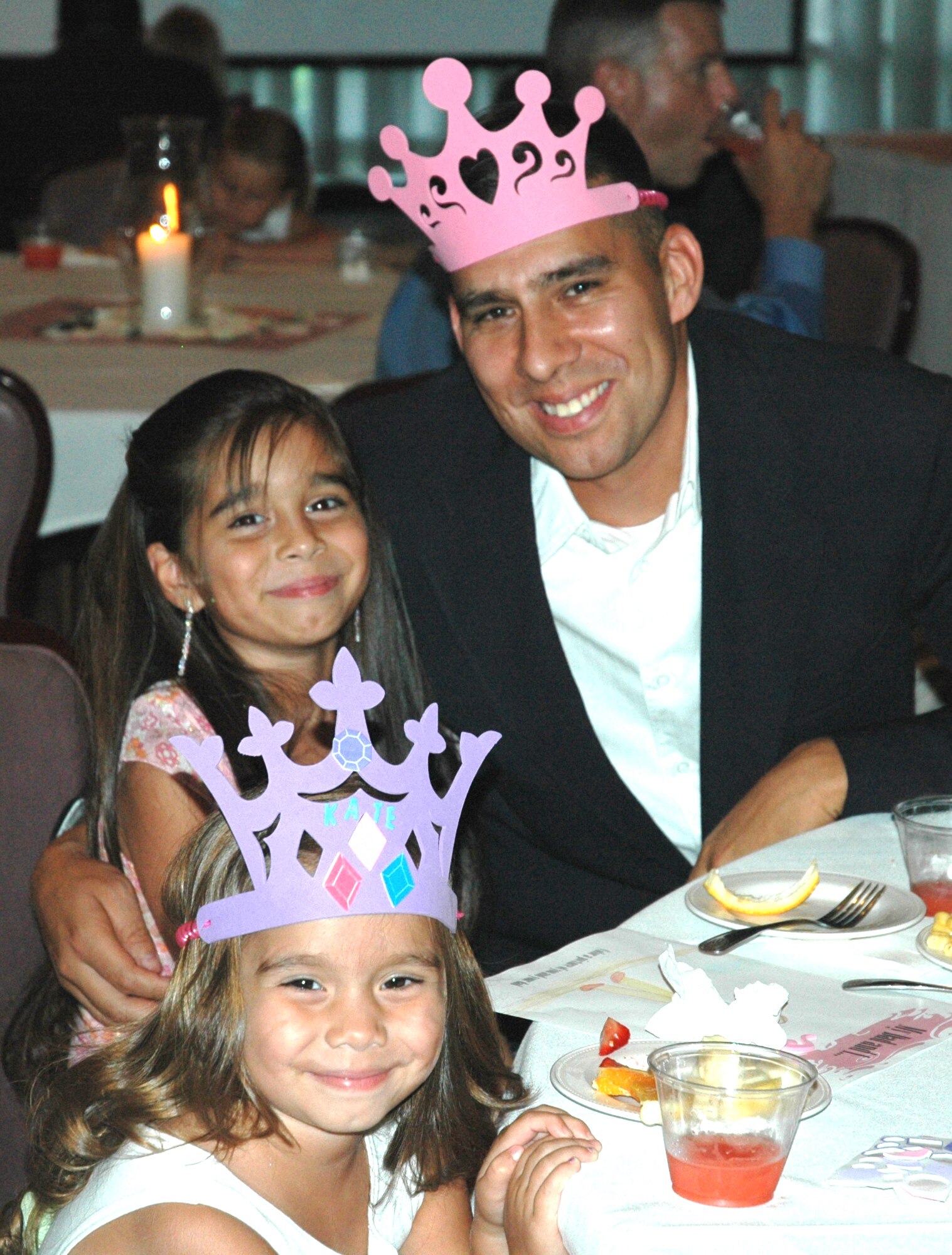 Capt. Francisco Vega, 82nd ATRS munitions officer, posed with his daughters Lauren (middle) and Katelijne (left) during the "Daddy Daughter Dance" hosted by the 325th Services Squadron July 24. Tyndall fathers brought their daughters out for a night of food, friends, dancing and fun at the Tyndall Heritage Club. 
