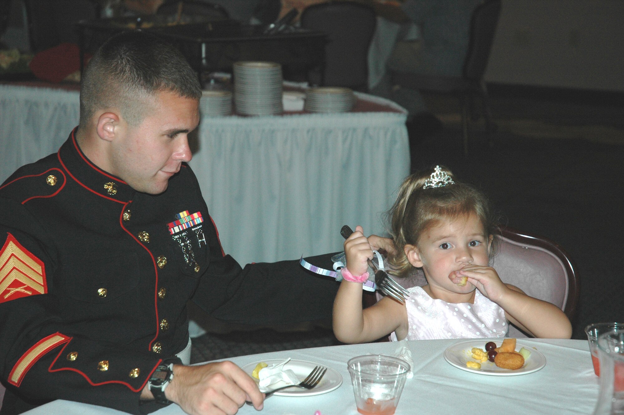 U.S. Marine Corps Sergeant Paul Rogers, local service recruiter, and his daughter Julia, enjoy hors d'oeuvres and beverages during the "Daddy Daughter Dance" hosted by the 325th Services Squadron July 24. Tyndall fathers brought their daughters out for a night of food, friends, dancing and fun at the Tyndall Heritage Club. 
